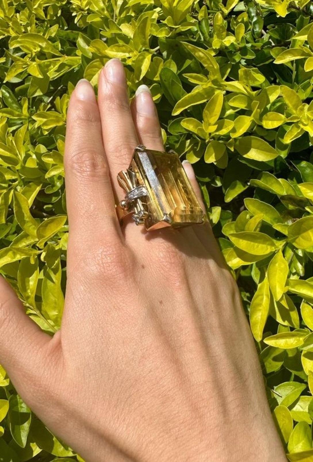 Circa 1940s. Art deco Retro Cocktail Ring crafted in 18k Rose Gold. Featuring a center natural yellow Citrine approximately 76.50 carats. Along with 10 single cut Diamonds on the side weighing approximately 0.40 carats. H-I graded color.

This 18k