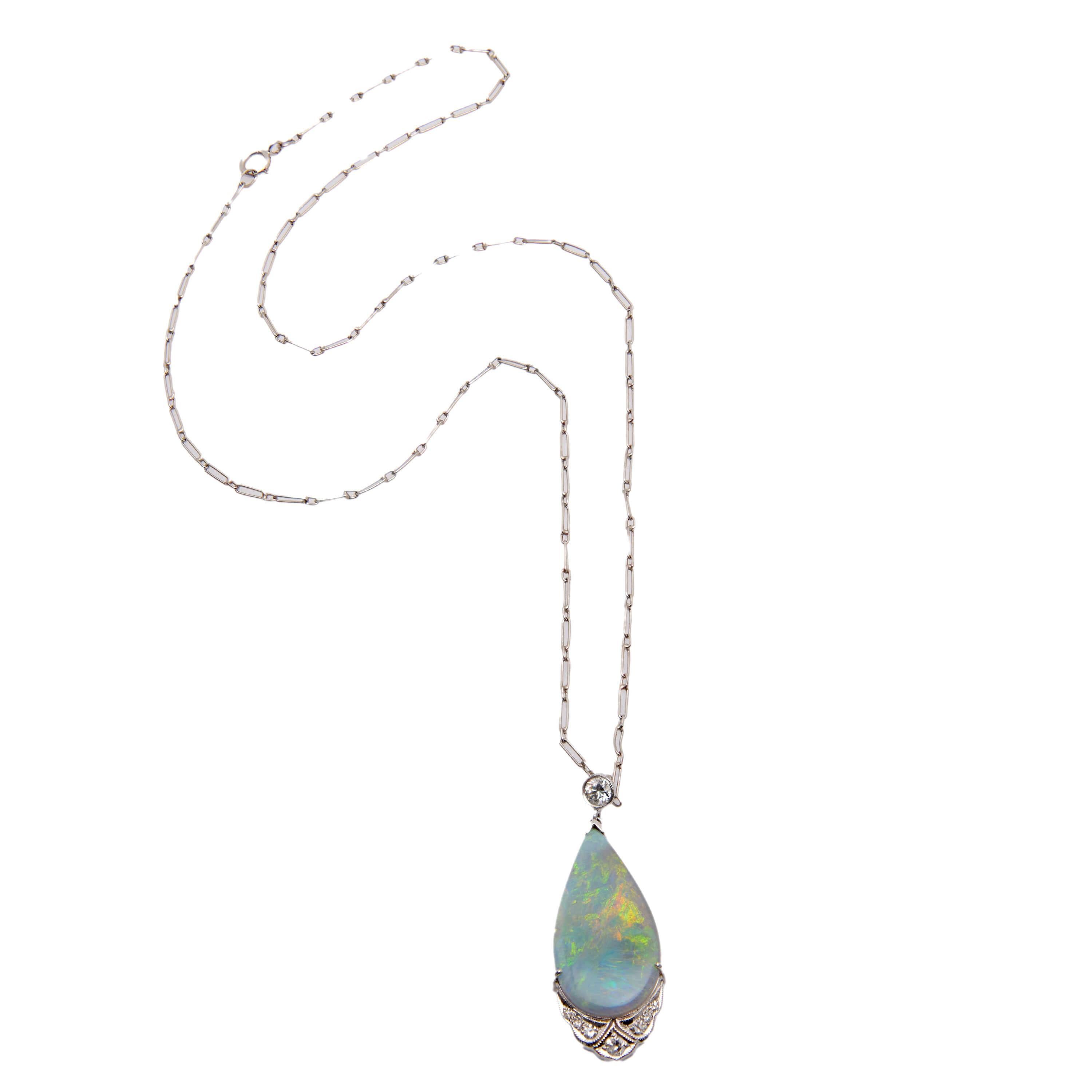 An eye-catching opal and diamond pendant necklace from the Art Deco (ca1920s) era! Crafted in 18k white gold, this necklace begins with a dainty paperclip chain, which secures with a spring ring clasp stamped 