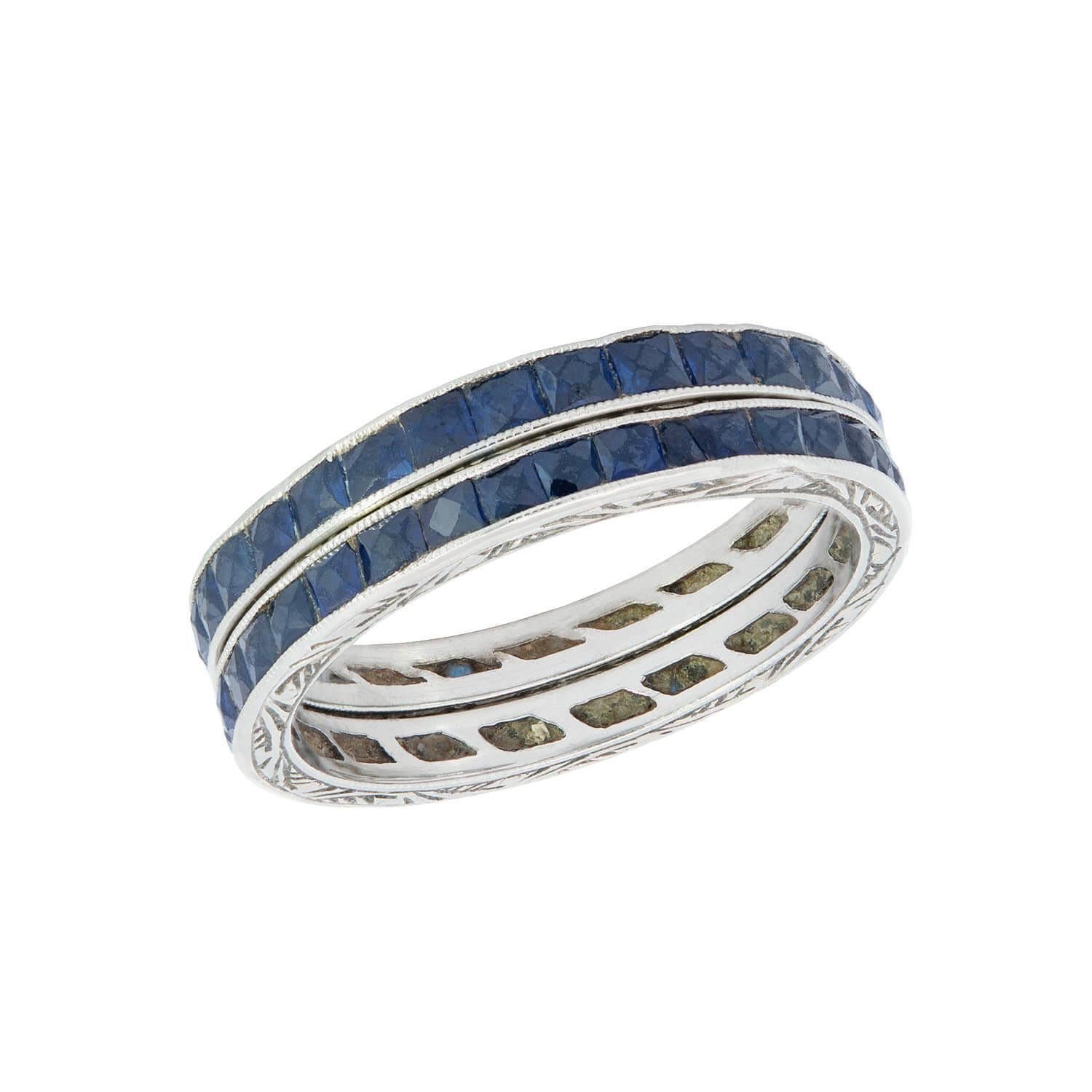 A beautiful sapphire eternity band set from the Art Deco (ca 1920) era! Crafted in 18k white gold, these simple yet lovely bands are comprised of a single row of vivid sapphire stones in a channel setting. The sapphires are French cut, and the