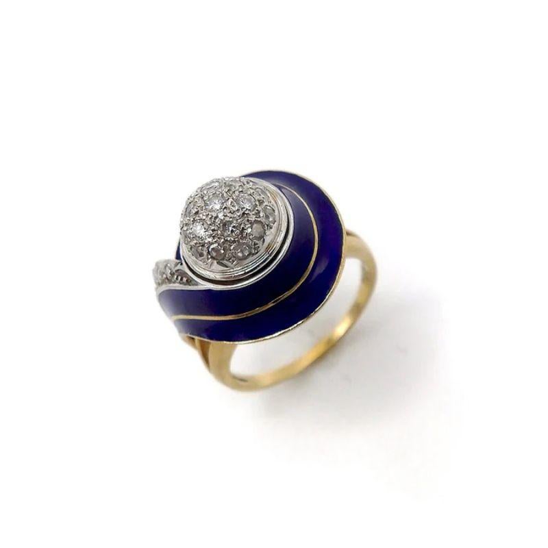 This is a gorgeous 18k white and yellow gold ring, made in Italy in the Art Deco period. The shape of this ring is quite unique, with a yellow gold shell-like swirl that extends and curls down the side. Laid over the gold is a deep blue enamel that
