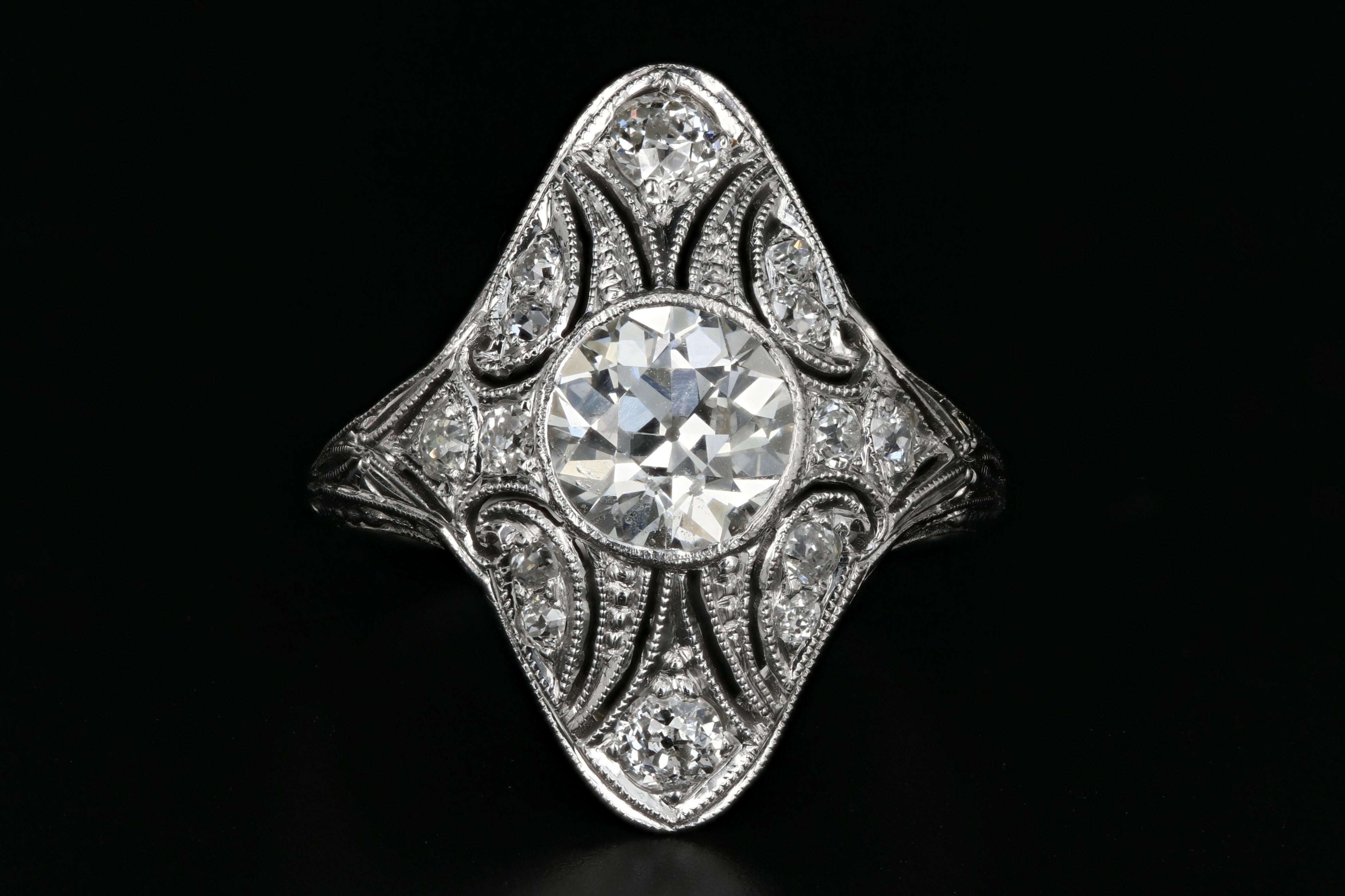 Era: Art Deco

Hallmarks: 18K

Composition: 18K White Gold

Primary Stone: Old European Cut Diamond

Stone Carat Weight: 1.15 Carats

Color/ Clarity: I / VS2

Accent Stone: Old European Cut Diamonds

Accent Stone Carat Weight: .30 Carats

Color/