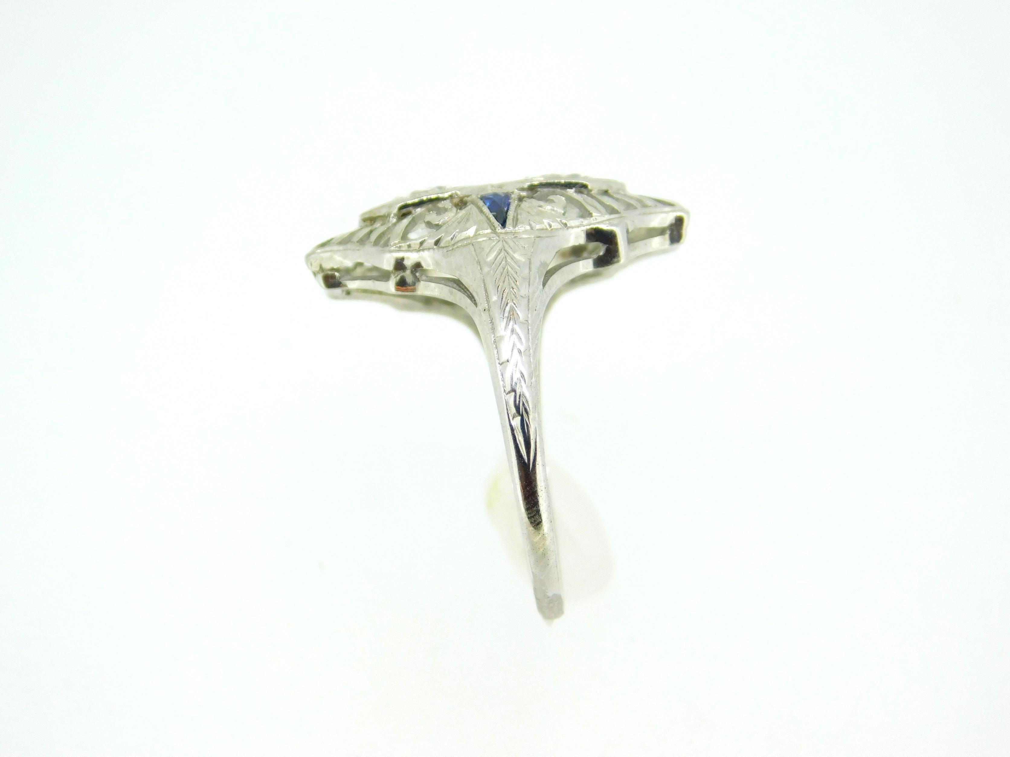 Art Deco 18k White Gold .92ct Diamond Filigree Ring (#J5050)

Art Deco 18k white gold featuring two round brilliant cut diamonds weighing about .92cts total and measuring about 4.8mm. The diamonds have VS2 to SI1 clarity and H-I color. There are two