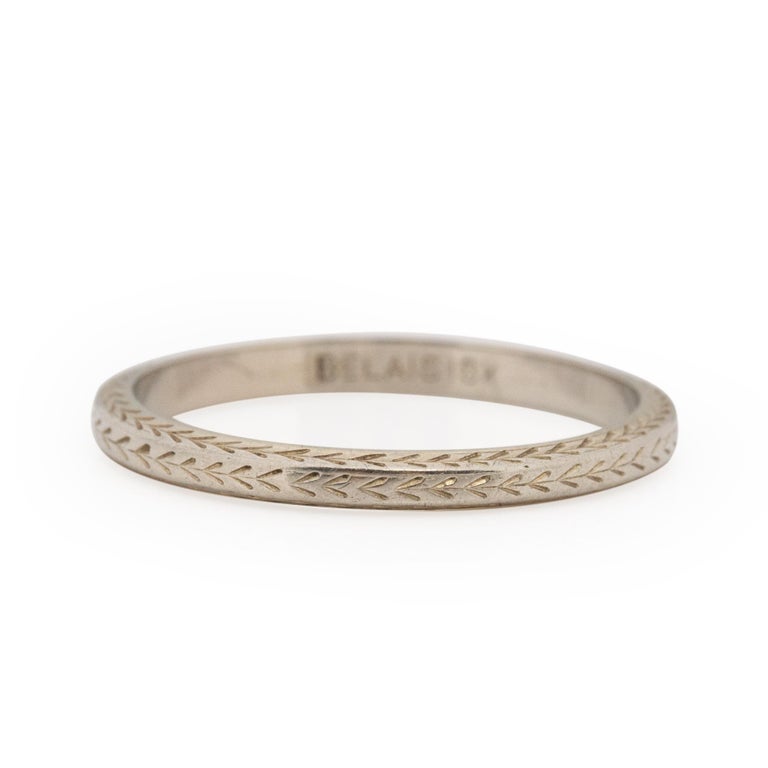 This signed Belais Bros beauty is a classic Belais design. Popular in the 1920's this 18K white gold band has three sides that are carved with a chevron design. The delicate details are visible at every turn. The repeating chevron pattern is simple,