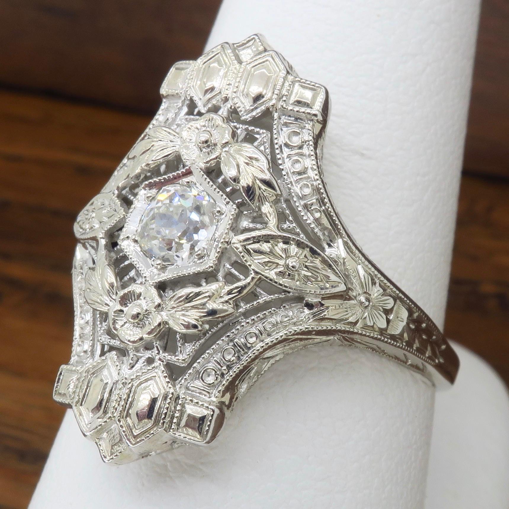 Art Deco 18K white gold diamond shield ring

Diamond Carat Weight: Approximately .36CTW
Diamond Cut: Old European Cut 
Metal: 18K White Gold
Weight: 3.9 Grams
Ring Size: 7.5-8