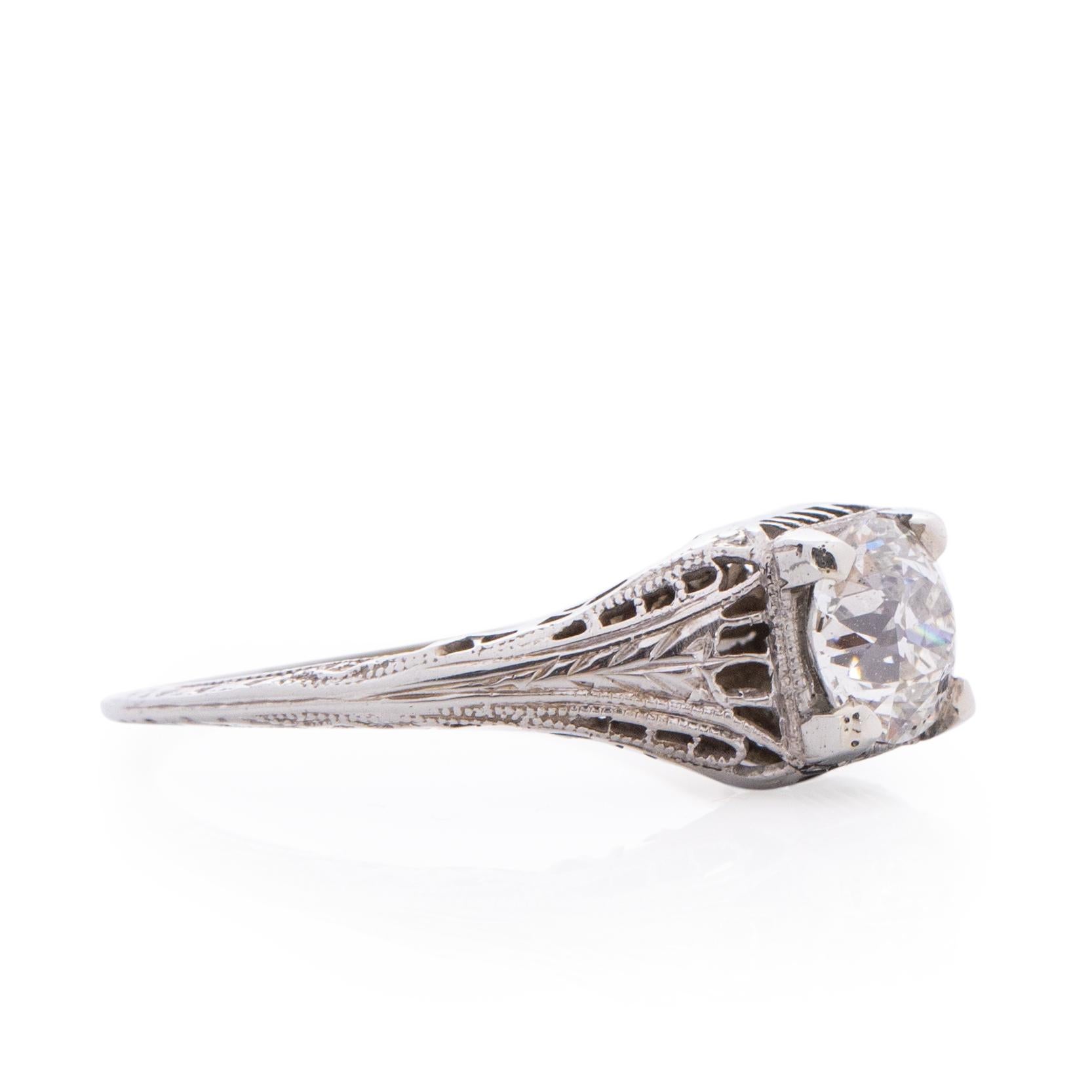 The gallery on this art deco filigree ring is outstanding! The geometric line design is intricate and clean, great condition for its age. This beautiful detail wraps up the shanks and holds a .90CT VS1 clarity diamond that is breath taking. The