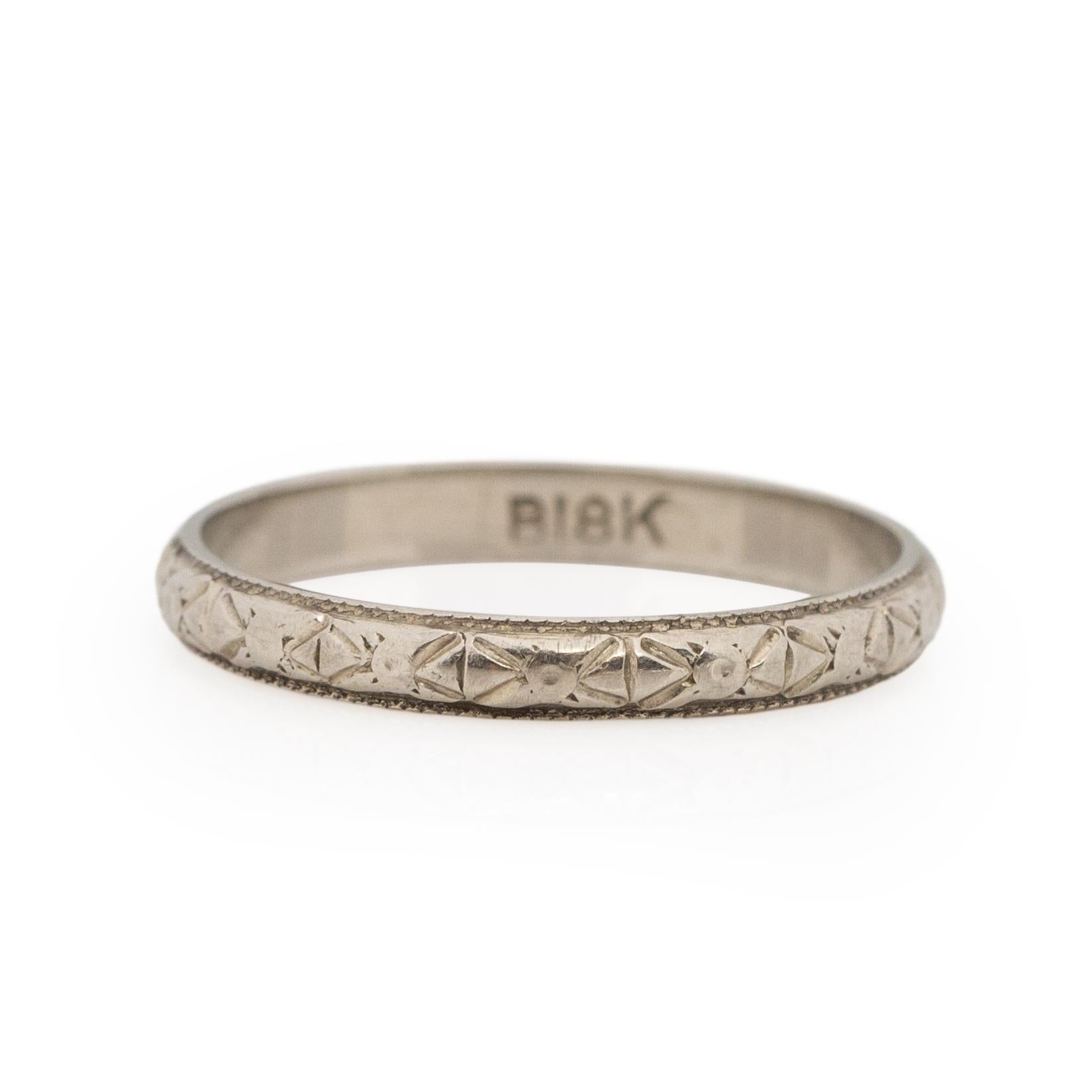 Here we have a petite, minimalist classic art deco hand carved band. This little baby is crafted in 18K white gold, in the center of a band is a beautifully carved repeating floral design, these types of designs were every popular in the 1920's.