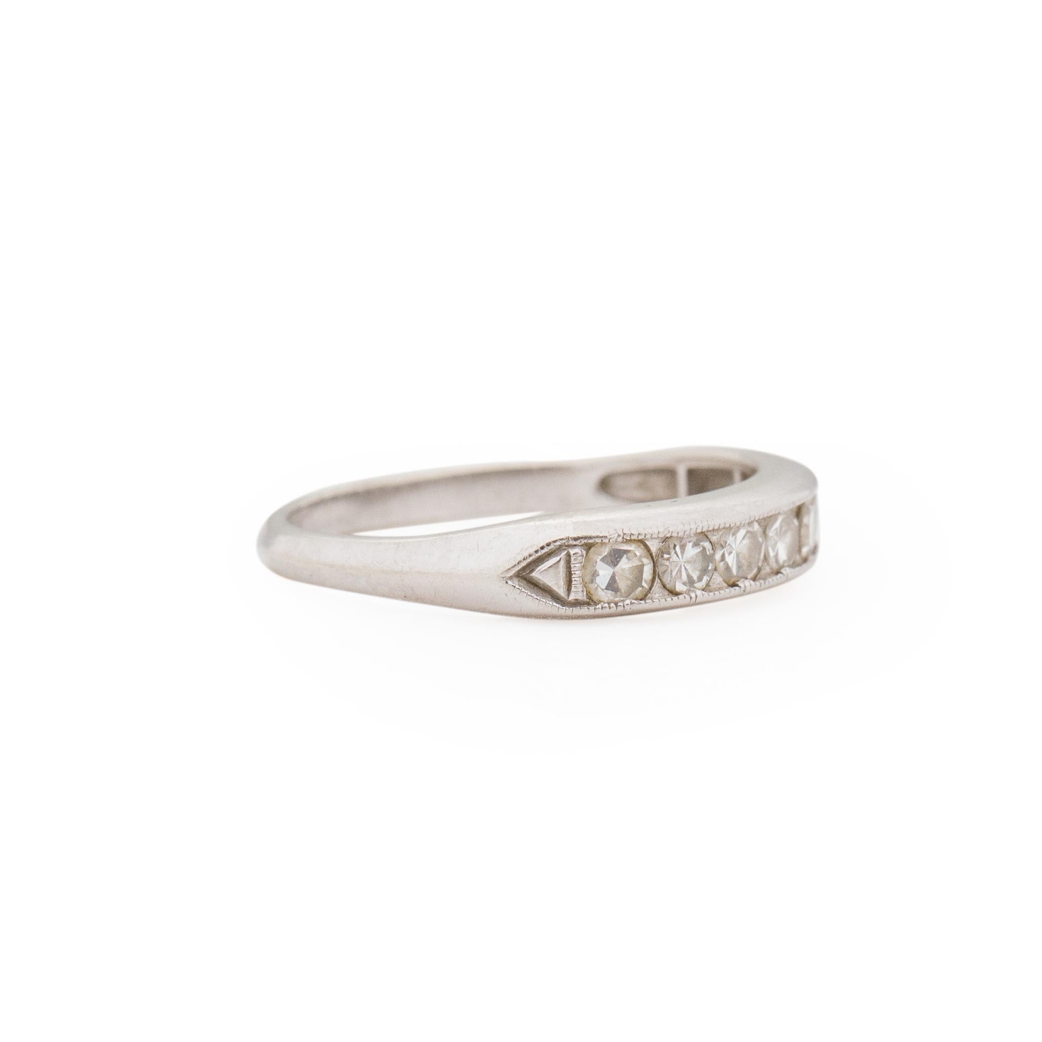 This deco beauty us a simple design, making it the perfect fit for any vintage or antique engagement ring weather it be for the big day or an anniversary surprise. This band is crafted in 18K white gold, along the top is seven beautiful single cut