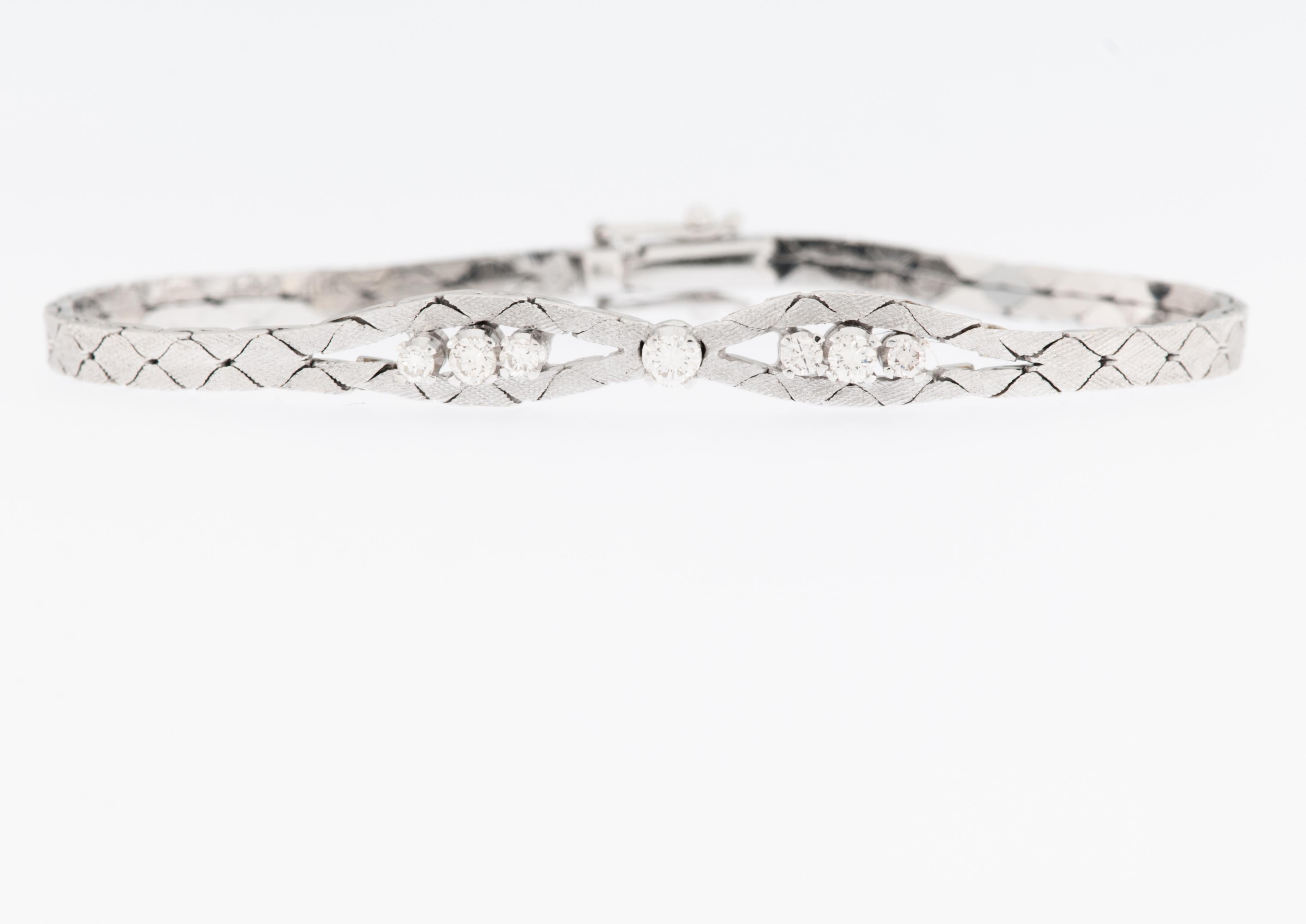 The Art Deco 18kt Satined White Gold Bracelet with Diamonds is a stunning piece of jewelry that embodies the elegance and sophistication of the Art Deco design era. Crafted from high-quality 18-karat white gold, the bracelet features a satin finish