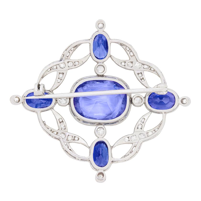 This exquisite brooch hails from the Art Deco period. It's set with an impressive 19.00 carats of natural, unheated/untreated, transparent blue sapphires, which have been independently certified by the Gem & Pearl Laboratory. The star of this brooch
