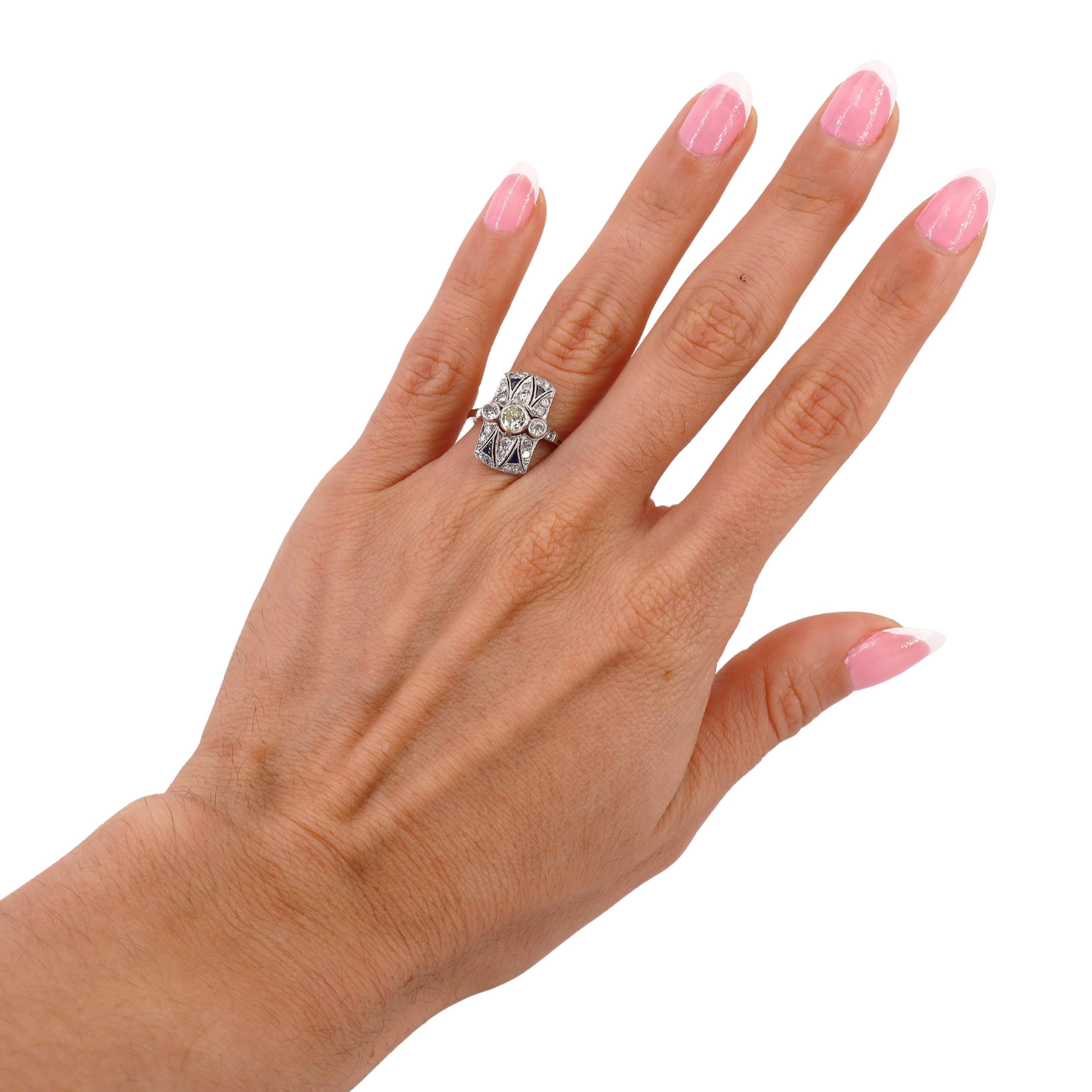 This breathtaking Art Deco ring, crafted during the 1915-1920s, is a masterpiece of vintage elegance and intricate design. Made from 18kt white gold, the ring features a stunning yellow diamond at its center, weighing approximately 0.25