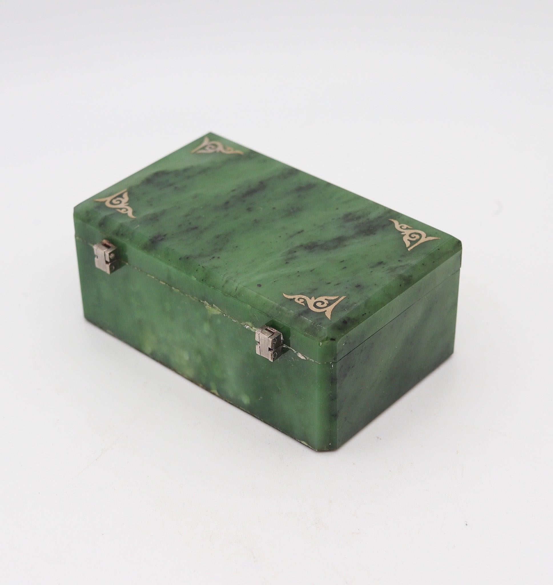 An art deco nephrite desk box.

This is a beautiful rectangular box created in Europe during the art-deco period, back in 1920. The box is fully crafted with carvings of translucent green nephrite and silver hardwares. Decorated with four inlaid
