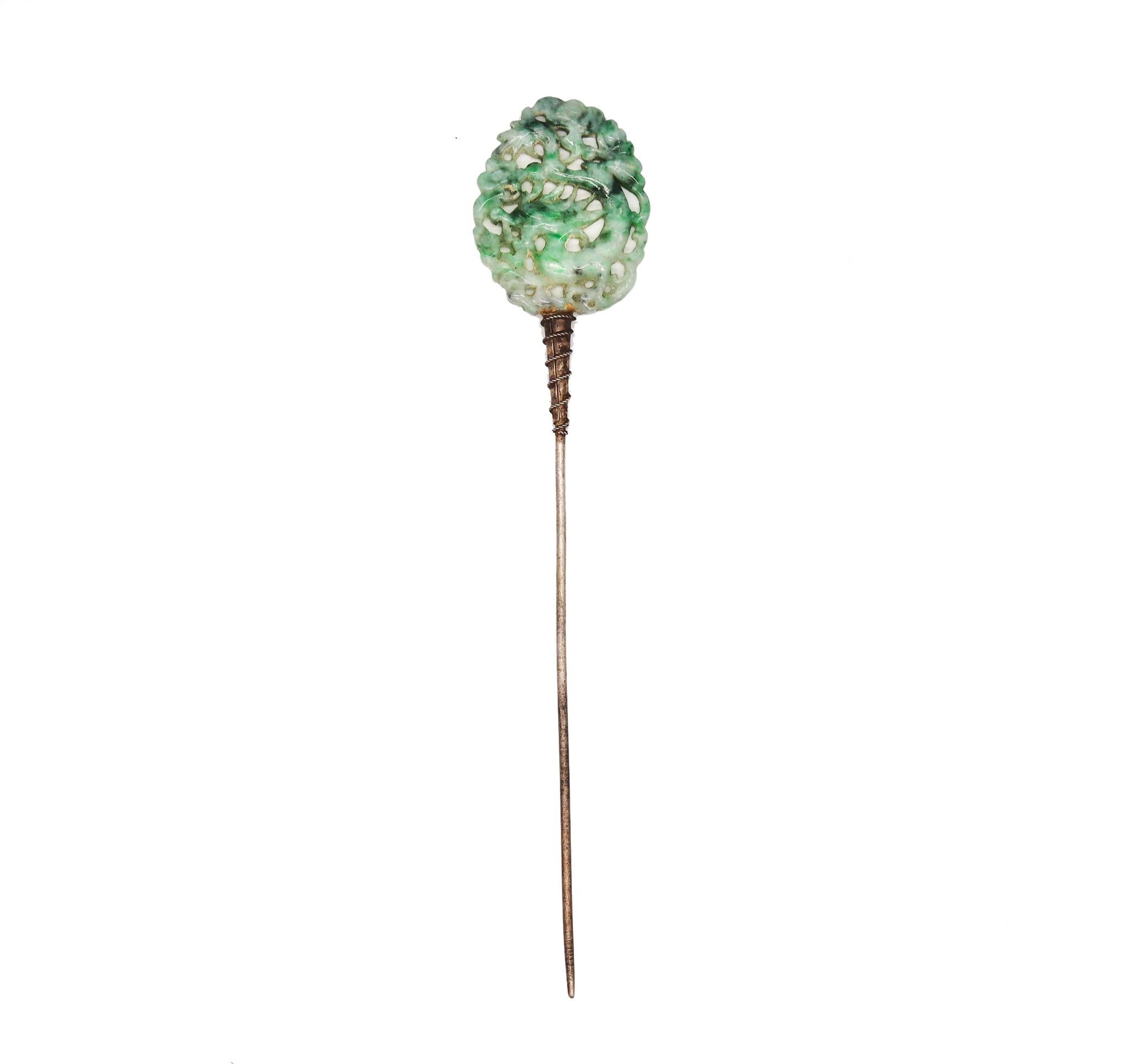 An art deco chinoiserie stick pin with green Jade.

Very nice antique piece from the European art deco period, circa 1920. This large hat-dress pin has been crafted with chinoiserie patterns in solid .800/.999 silver and mounted on top with a