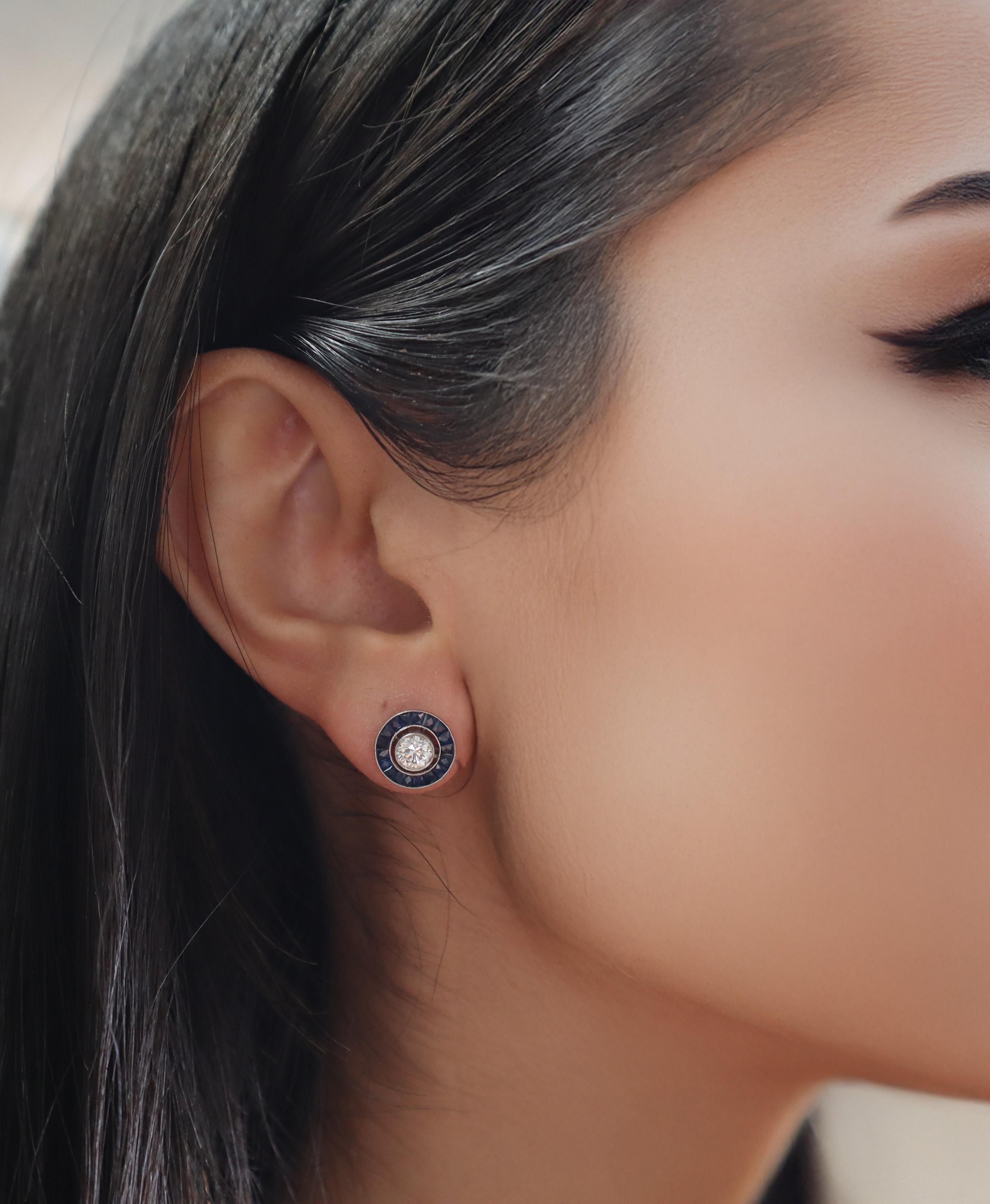 This exquisite pair of stud earrings showcases a harmonious blend of luxurious materials and expert craftsmanship. At the center of each earring is a dazzling European-cut diamond, weighing approximately 0.82 carats. The diamonds exhibit a pristine