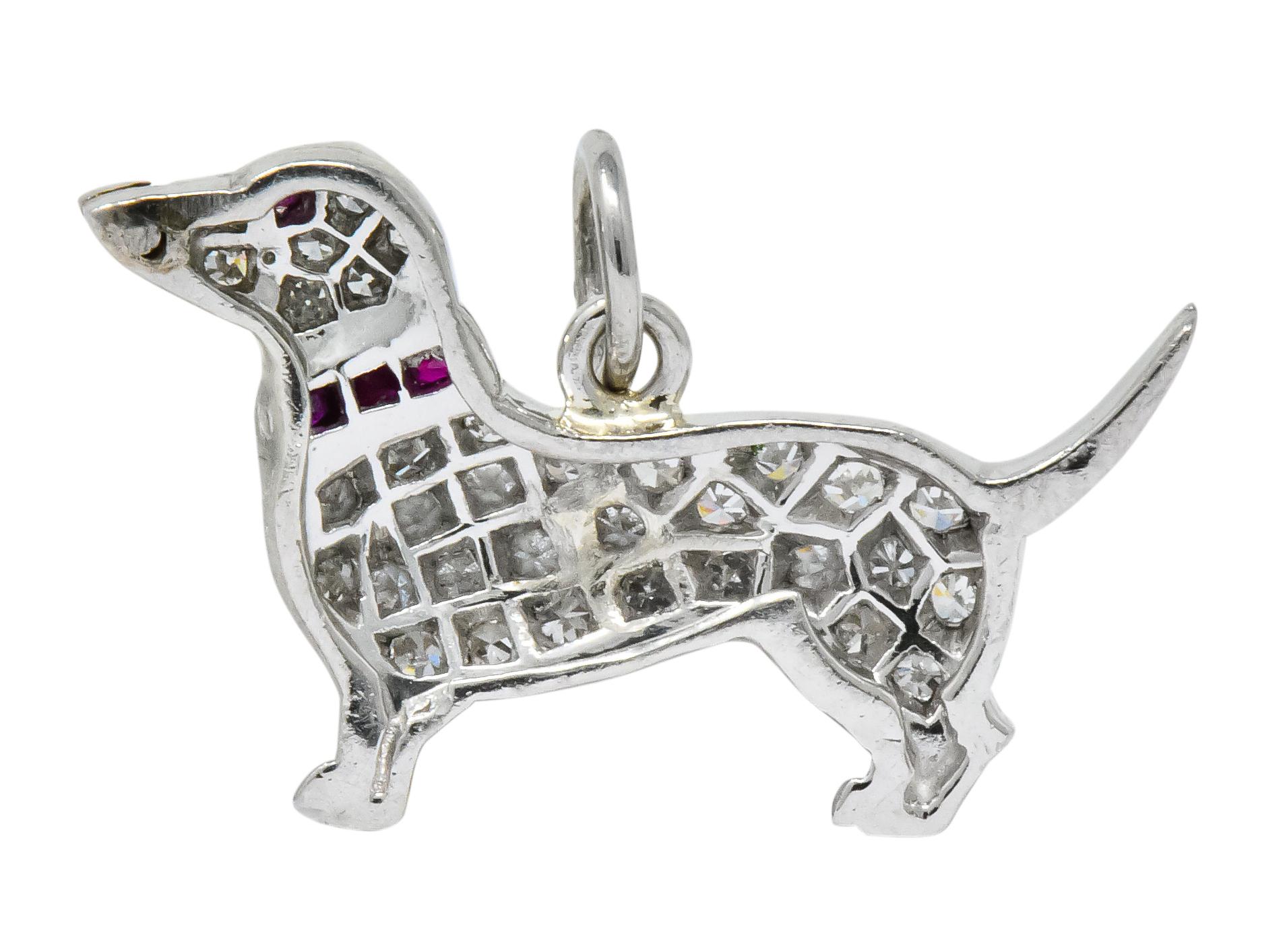 Dachshund dog charm pavé set throughout with single cut diamonds weighing approximately 0.25 carat, eye-clean and white

With small round cabochon ruby eye, and channel set calibré cut ruby collar

Accented by high polished nose, feet, and