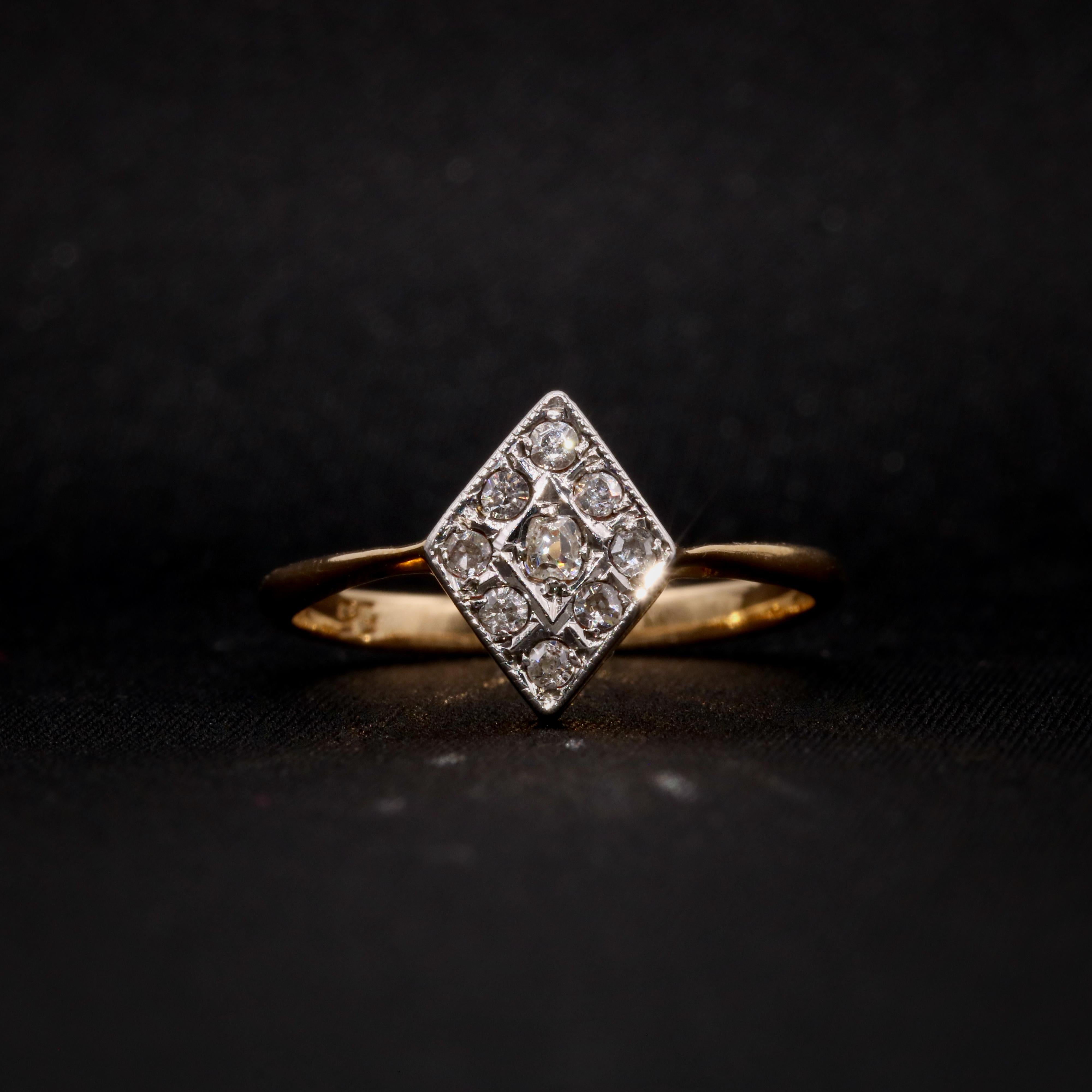 An Art Deco diamond, platinum, and yellow gold ring, comprising one old mine cut diamond, and nine old single cut diamonds, set in platinum and 18 karat yellow gold, to an 18 yellow gold band. 

This Art Deco ring has a lozenge shaped head, set with