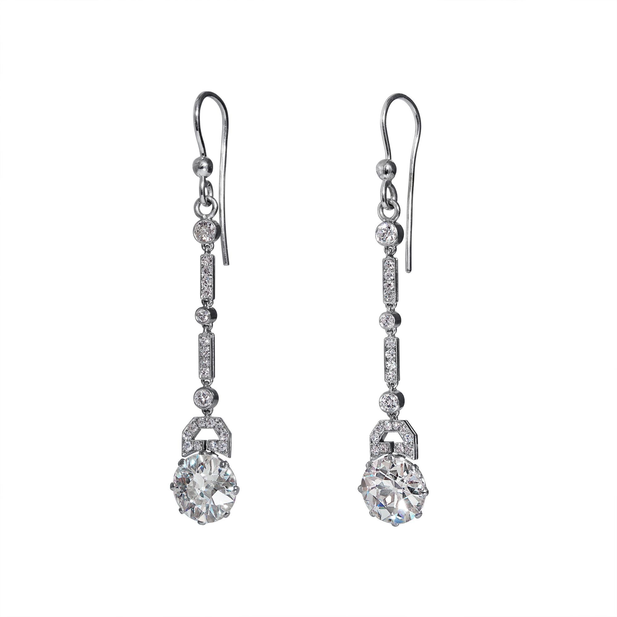 A sleek and sexy pair of ART DECO 5.71ctw Diamond Drop Earrings in Platinum, dating from CIRCA 1920s.

Unique and Exquisite pair of these Authentic Art Deco Earrings will take your breath away! Platinum Dangles are encrusted with Old European and