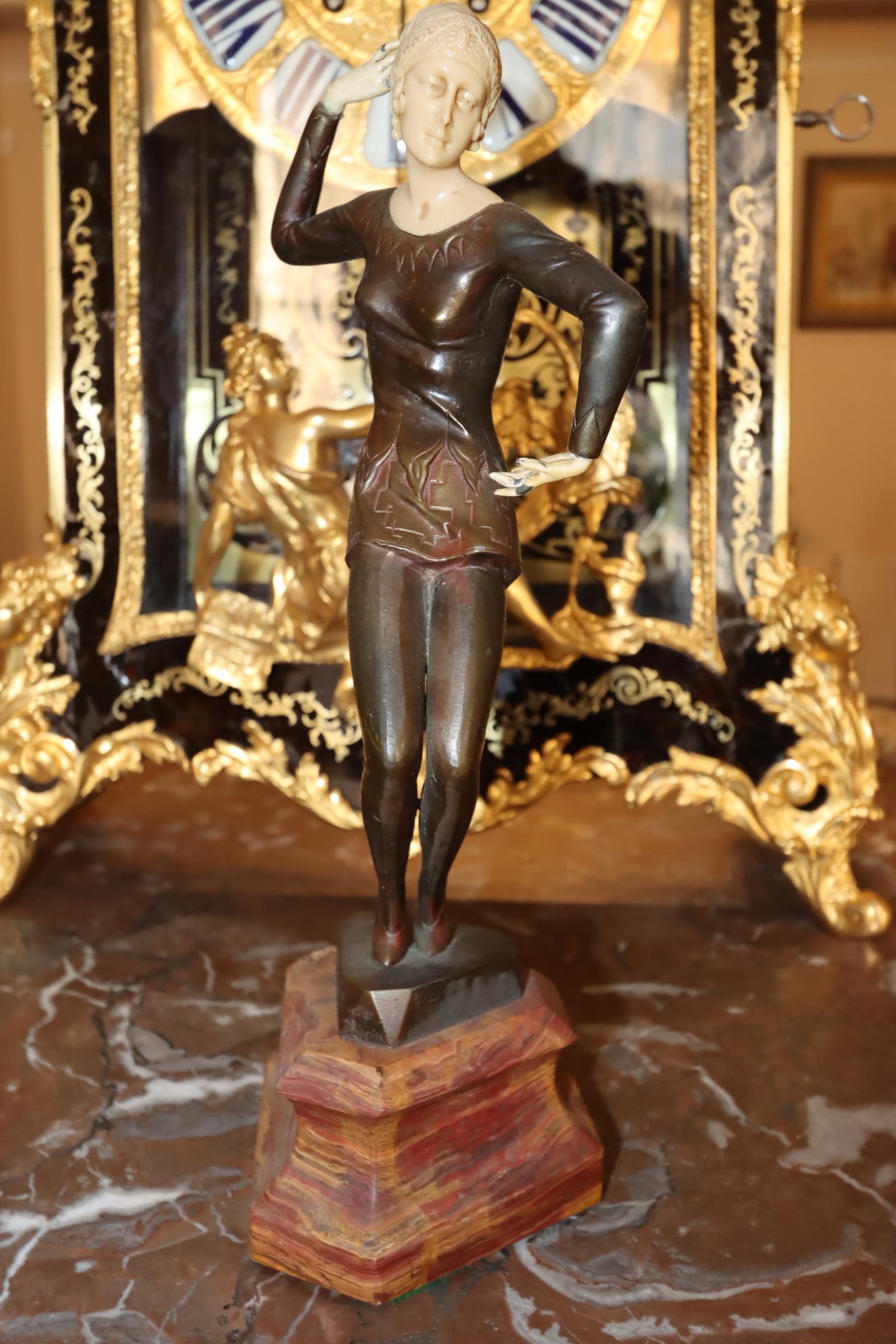 Capturing the spirit of the Roaring Twenties, this exquisite Art Deco figurine titled 'Ballerina' is a mesmerizing blend of bronze and bone. Gracefully poised in a dynamic dance pose, the sleek lines and geometric elegance of the Art Deco era are