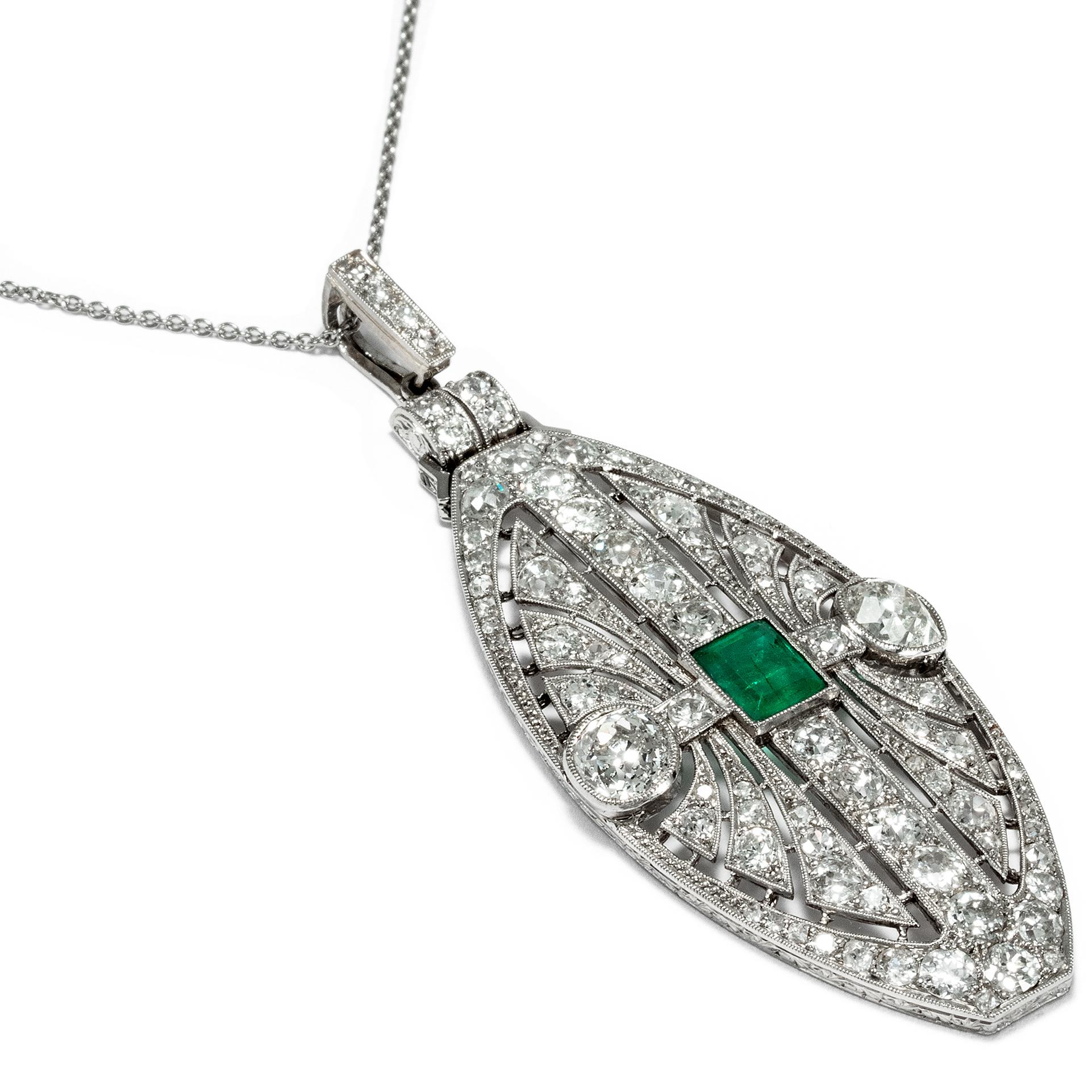 This exquisite pendant is a typical example of fine 1920s Art Déco jewellery. With its large shield form, it is perfectly suited to showcase the exceedingly painstaking detail in which the best of the era's goldsmiths were able to execute their