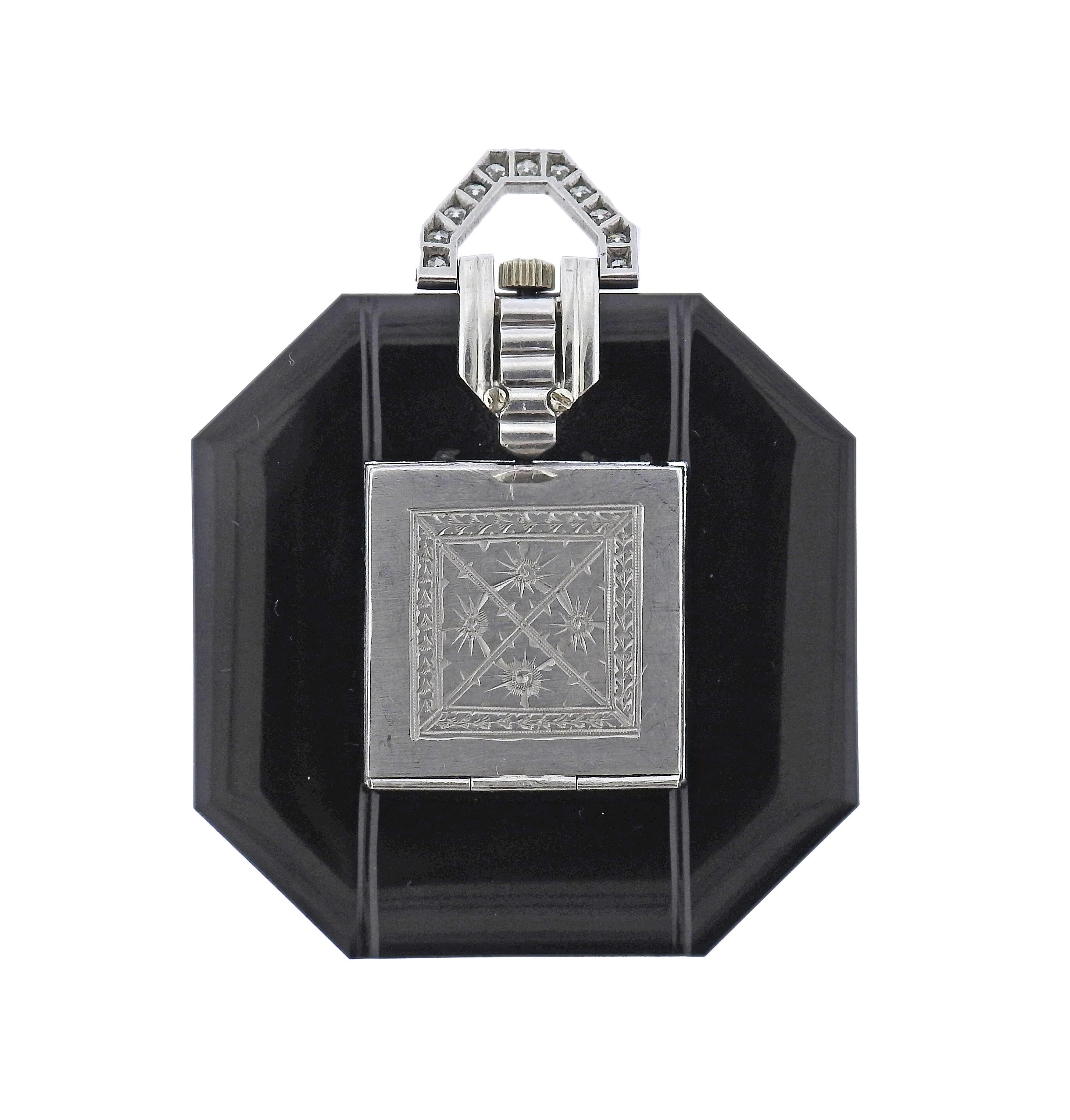 Art Deco platinum watch pendant, set with onyx case, decorated with diamonds. Case measures 53mm with bale x 44mm. Watch movement in working order -  manual wind. Weight of the piece - 33.5 grams. 