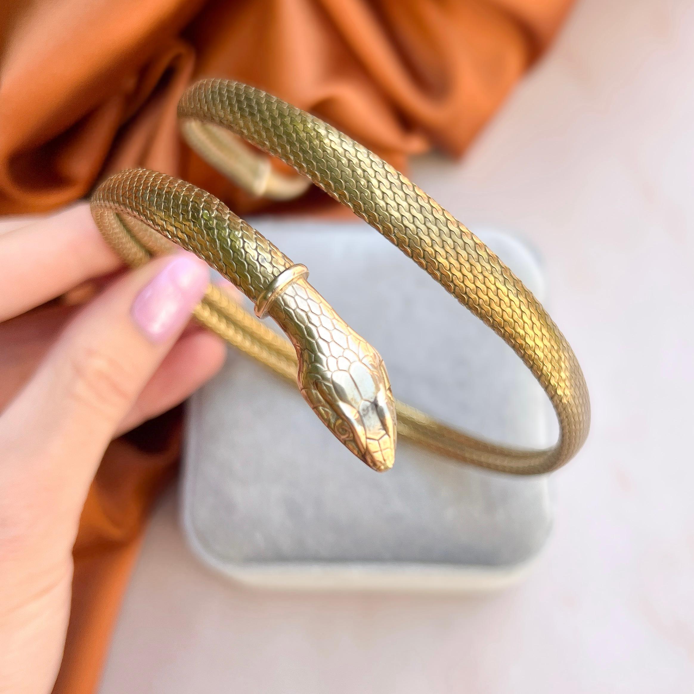 This stylish snake choker dates from the 1920s. 

Condition Report:
Very Good - A little rubbing to the gold plated surface in a couple of small areas. This is only apparent upon very close inspection and does not detract from the appeal of the