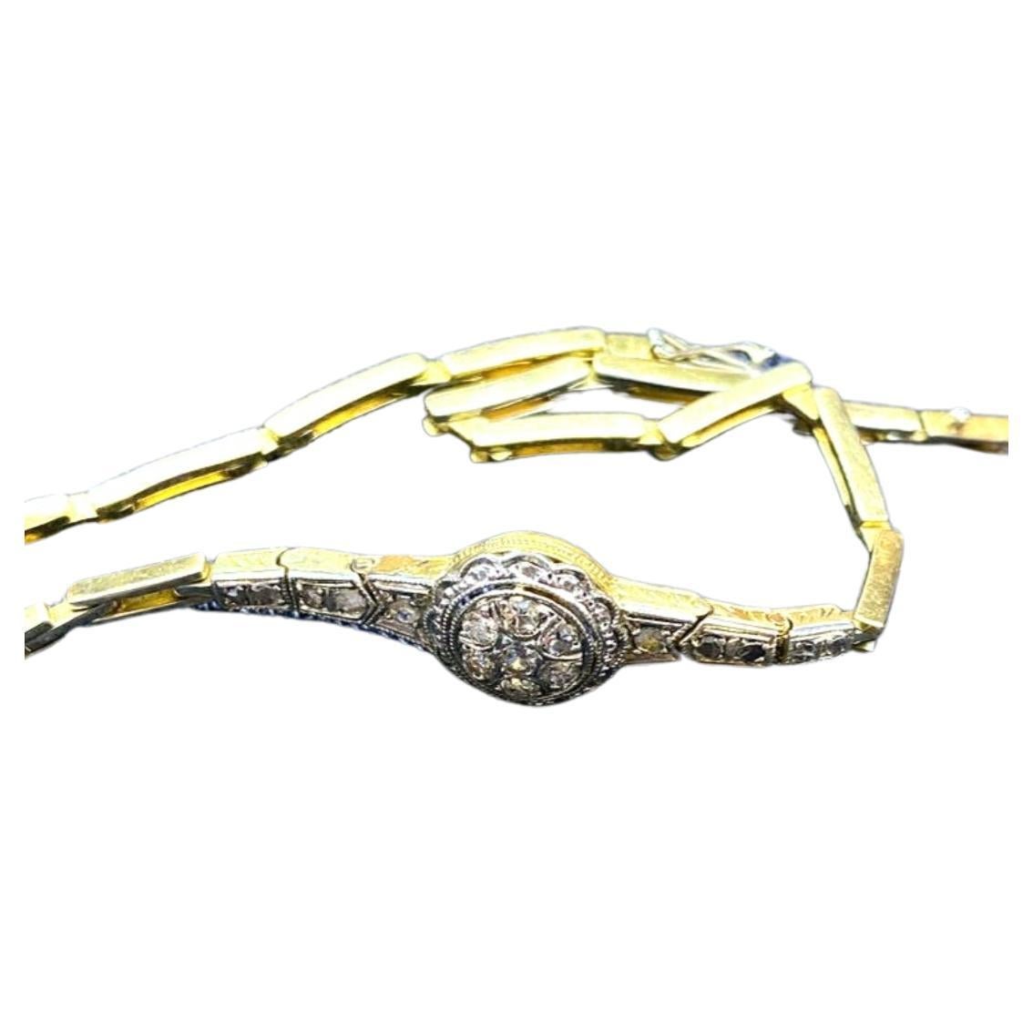 Antique bracelet art déco en or 18k surmonté de platine dans une tête de bracelet circulaire centrée avec des diamants de taille ancienne flanqués avec des diamants de taille rose avec un travail de détail gravé sur les côtés du bracelet hall marqué