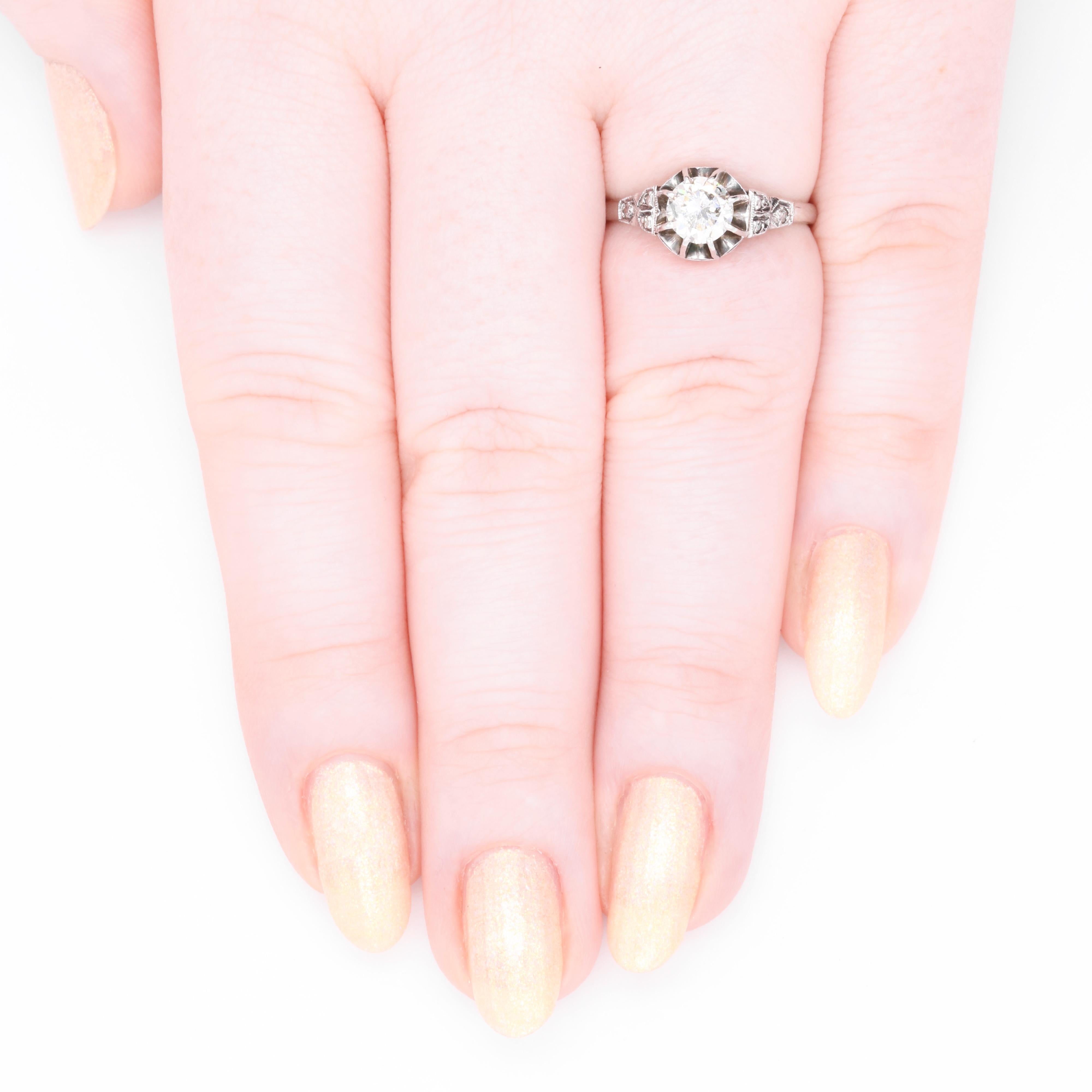 A platinum and diamond ring, comprising one round transitional cut diamond, and six rose cut diamonds, set in platinum, to a platinum band. 

This show-stopping ring is striking in its design. Set to the centre is a large, transitional cut diamond.