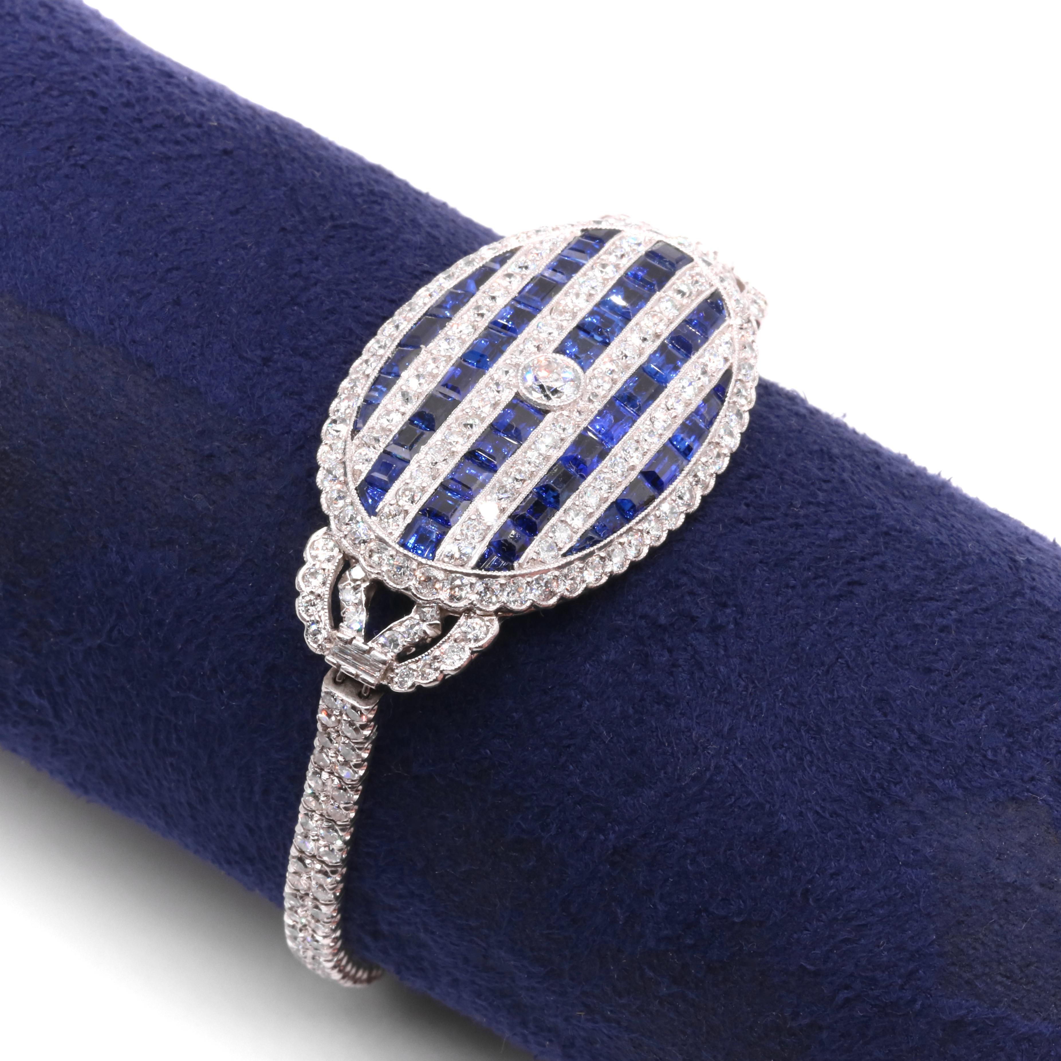 An Art Deco sapphire, diamond, platinum, and white gold bracelet, comprising one old European cut diamond, two baguette cut diamonds, two-hundred-and-thirty-nine old round cut diamonds, and forty-six calibre step cut sapphires, set in platinum and