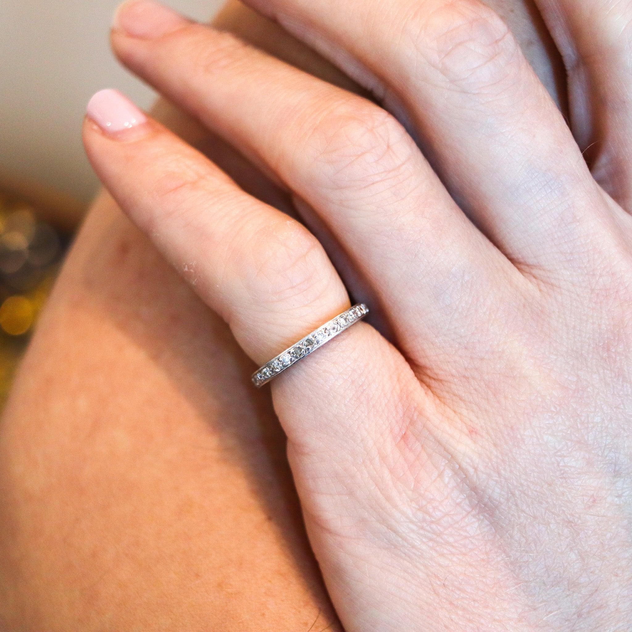 An eternity ring band with Natural Diamonds.

This is a beautiful eternity ring, made in America during the art-deco period, back in the 1925. The ring was carefully crafted in solid .900/.999 platinum with high polished finish and embellished
