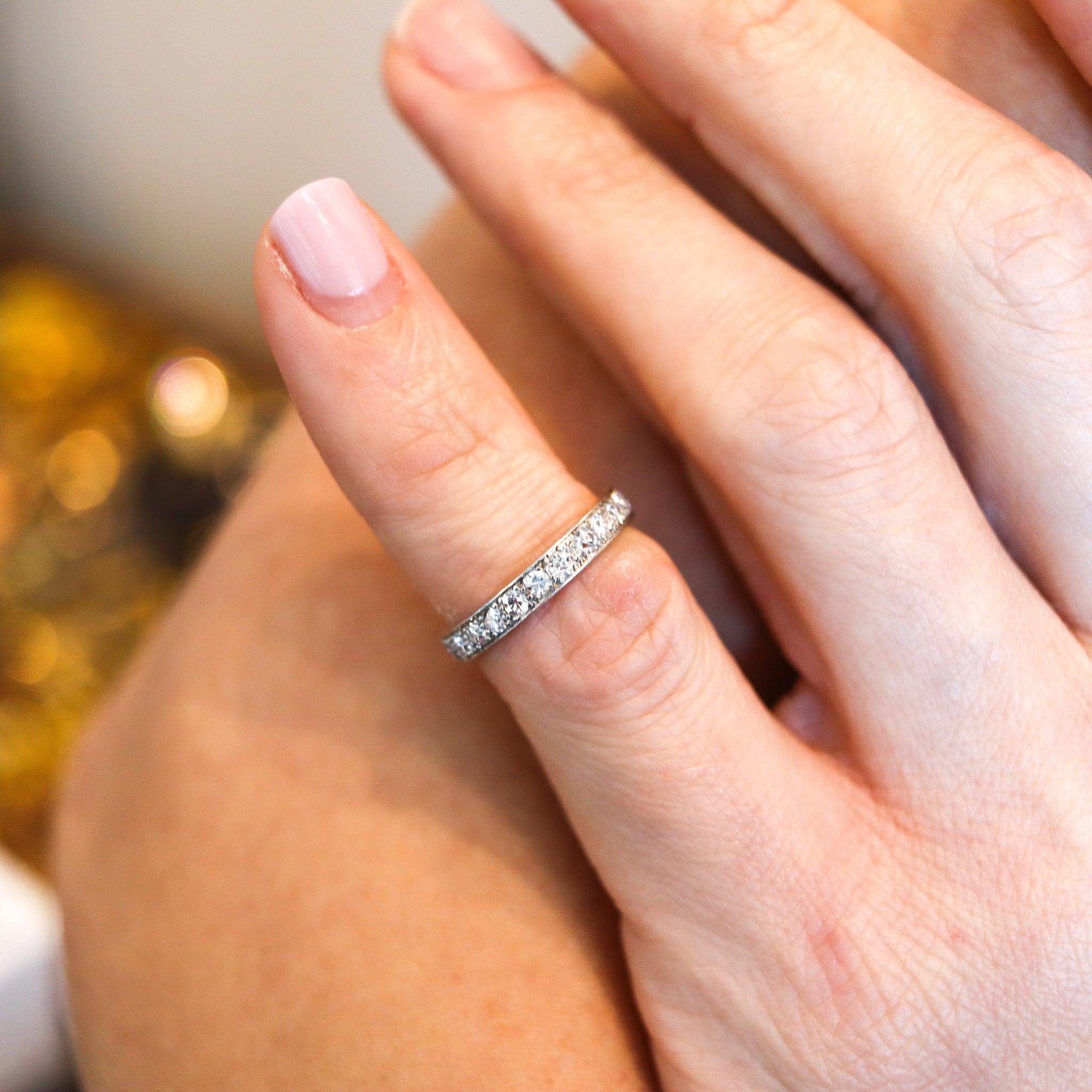 An eternity ring band with Natural Diamonds.

This is a beautiful eternity ring, made in America during the art-deco period, back in the 1925. The ring was carefully crafted in solid .900/.999 platinum with high polished finish and embellished