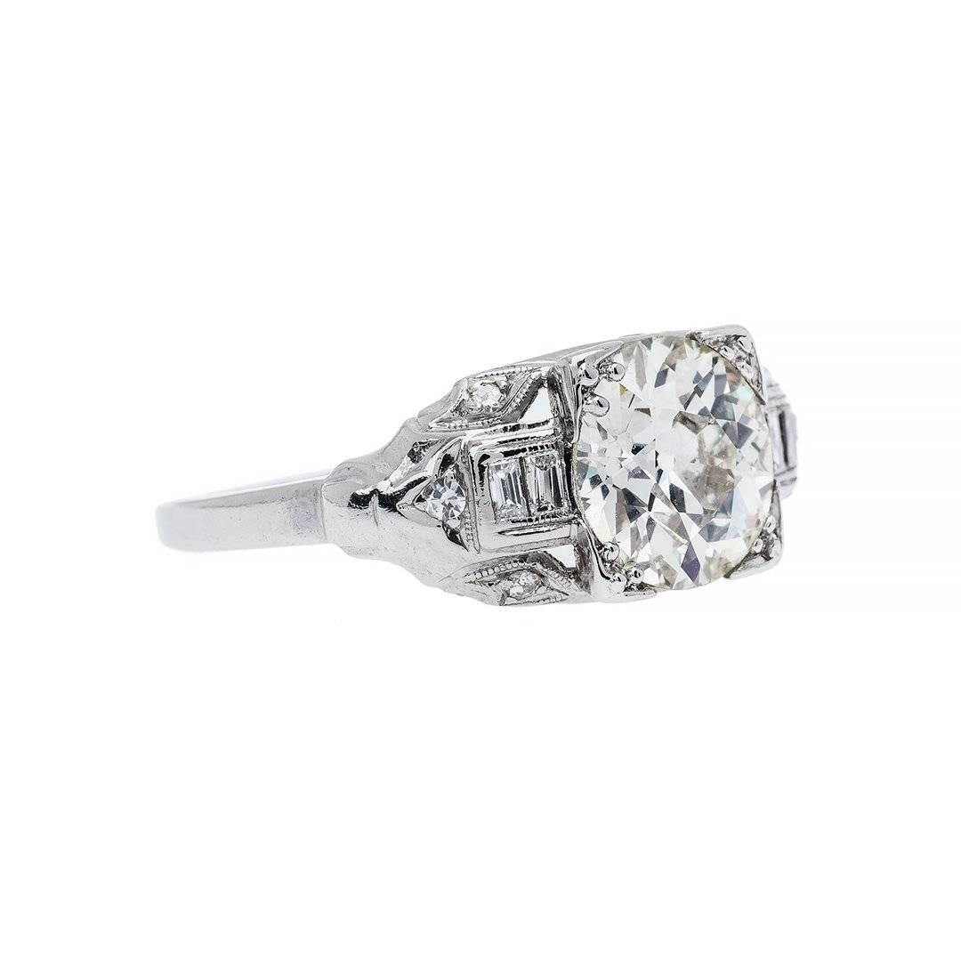 The art deco time period was first built to protect the vision that is still projected today. Designed with a 1.93 carat old european cut diamond that is K-L color, VS clarity. Aesthetically accented by numerous near colorless diamonds. Crafted in