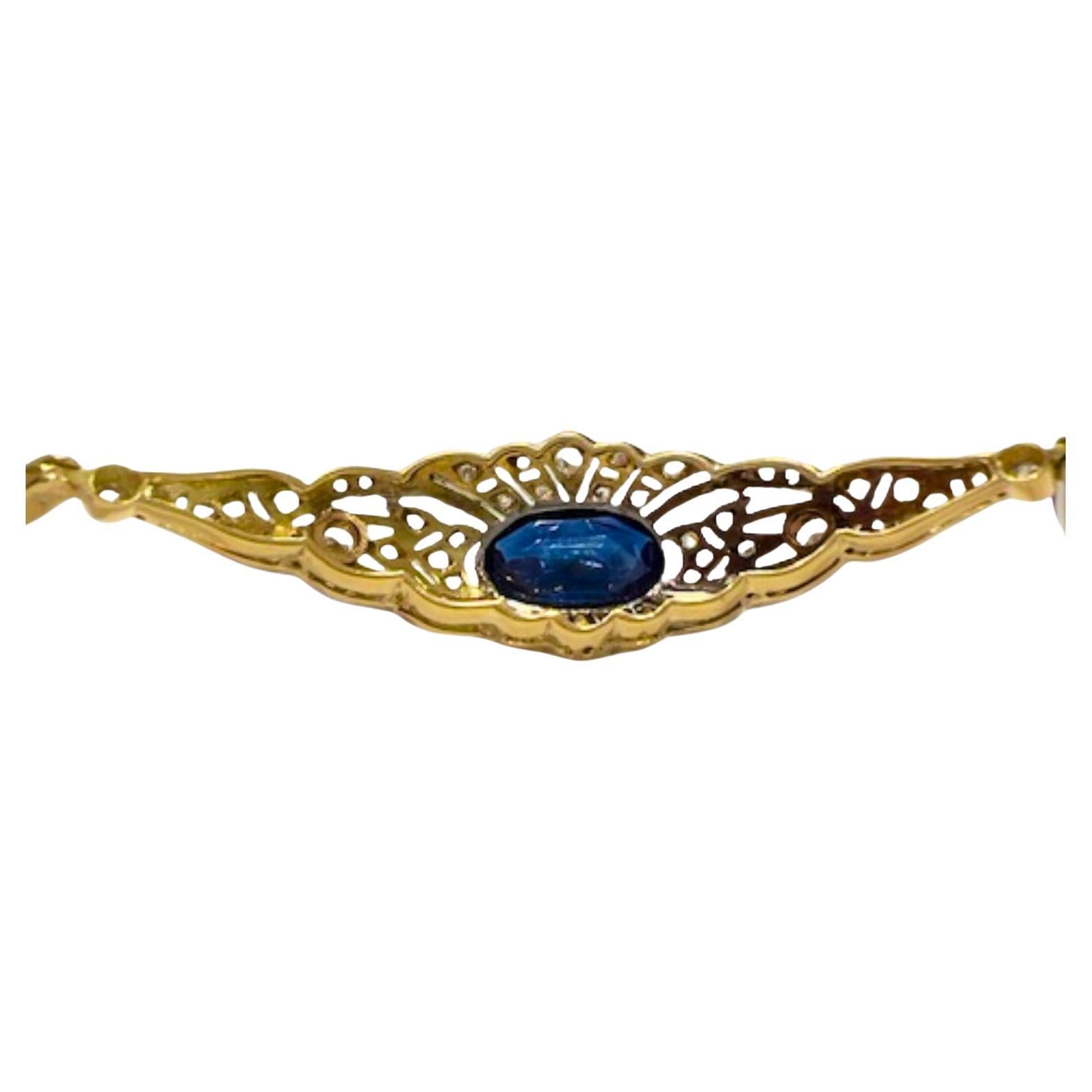 This Art Deco bracelet from the 1930-1935 era is crafted in 18K gold with 950 platinum accents, featuring diamonds and sapphires. 
It has a weight of 7.45 grams. The bracelet is adorned with rose-cut diamonds, totaling 0.50 carats, with commercial