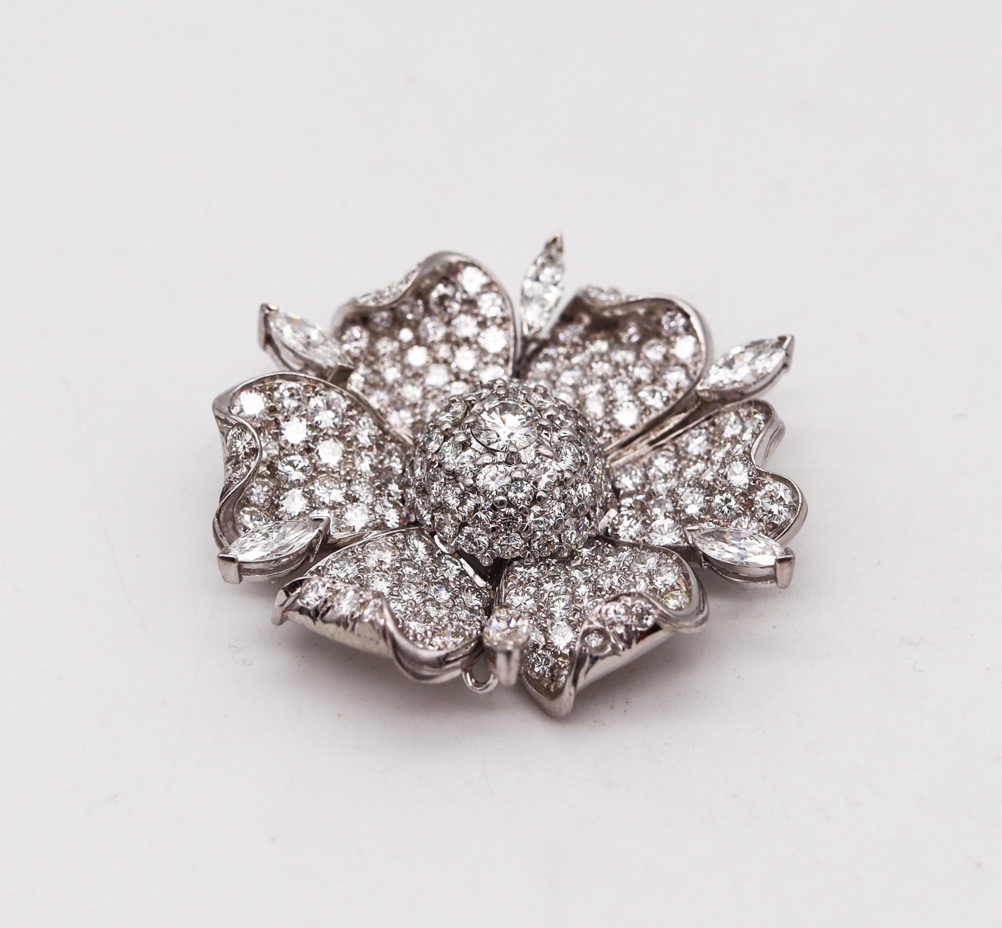 An art-deco gem-set brooch.

Gorgeous piece from the late American art deco period, circa 1930's. This beautiful brooch was carefully assembled from several elements crafted in the shape of a flower with stepped petals, in solid .900/.999 platinum