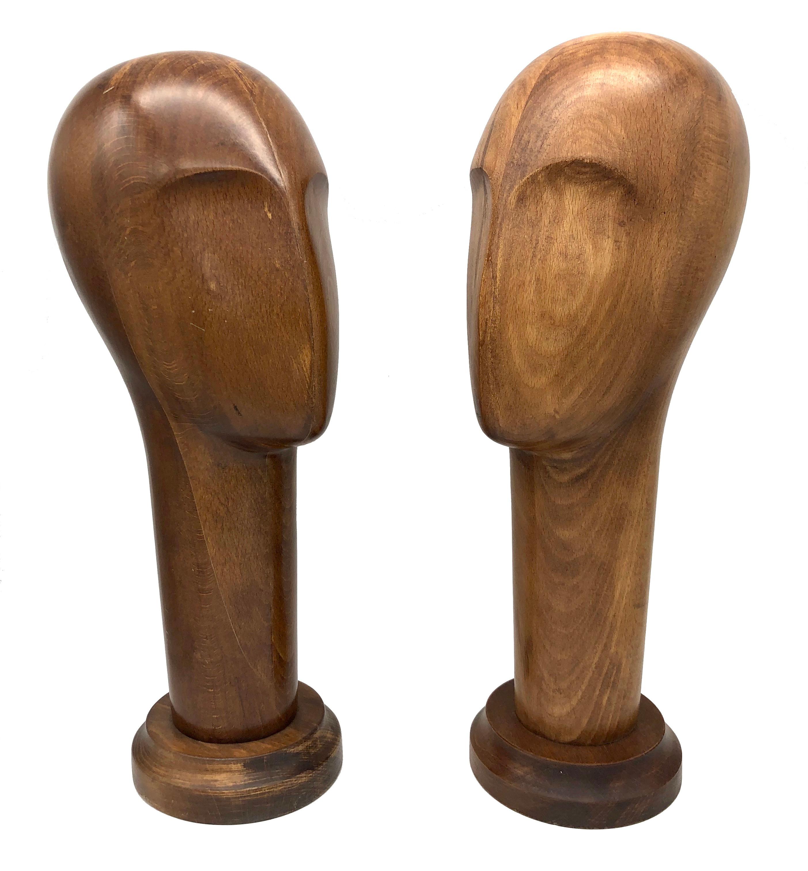 This pair of wonderfully carved wooden bust were meant most likely for hats. Their abstraction and their quiet charm owes inspirtion to sculptor  Constantin Brancusi.
 