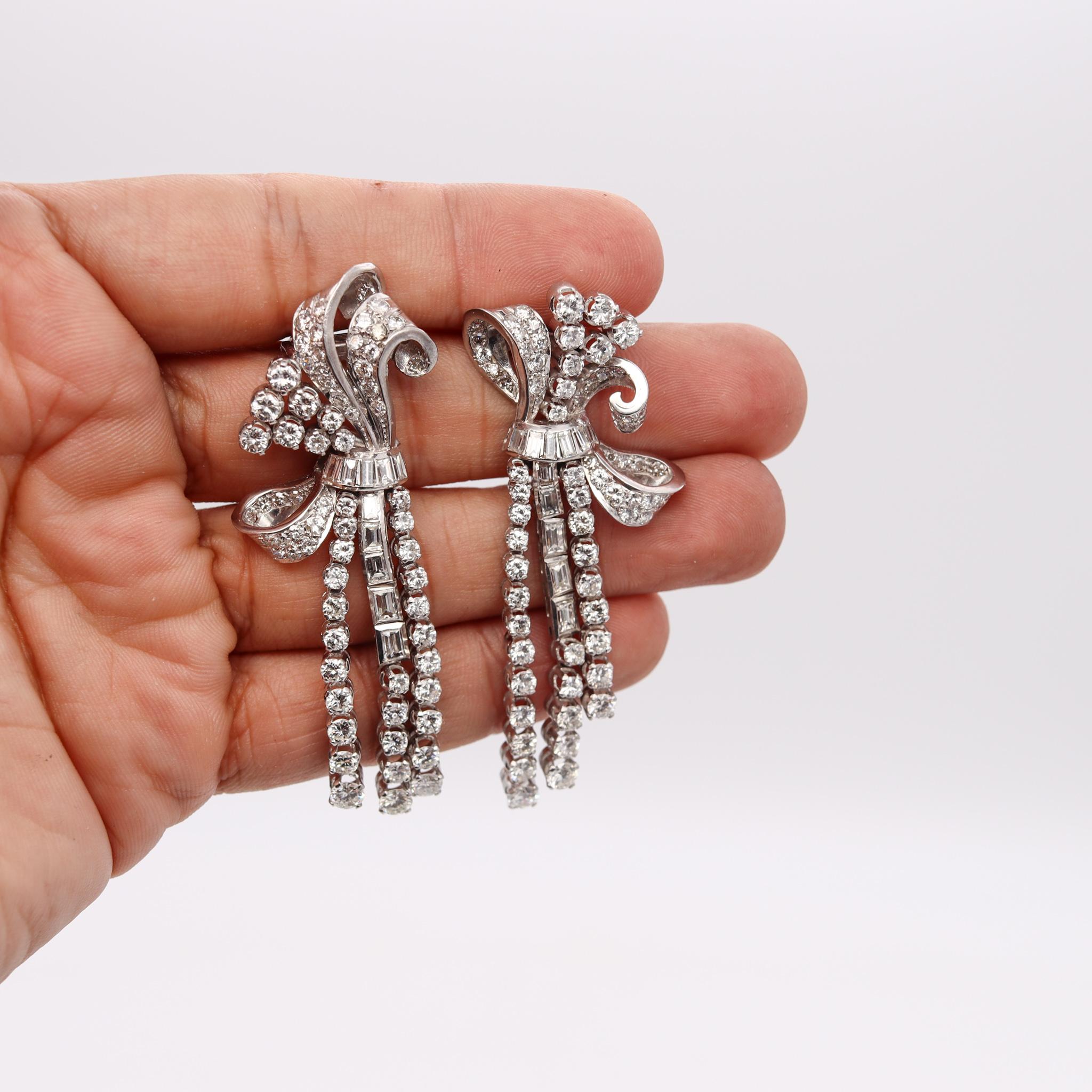 Gorgeous pair made during the American Art-Deco period, circa 1930's. This exuberant pair of jeweled clips has been carefully crafted in solid .900/.999 platinum with multiples movable parts, simulating a jeweled cascade. Each one is suited at the