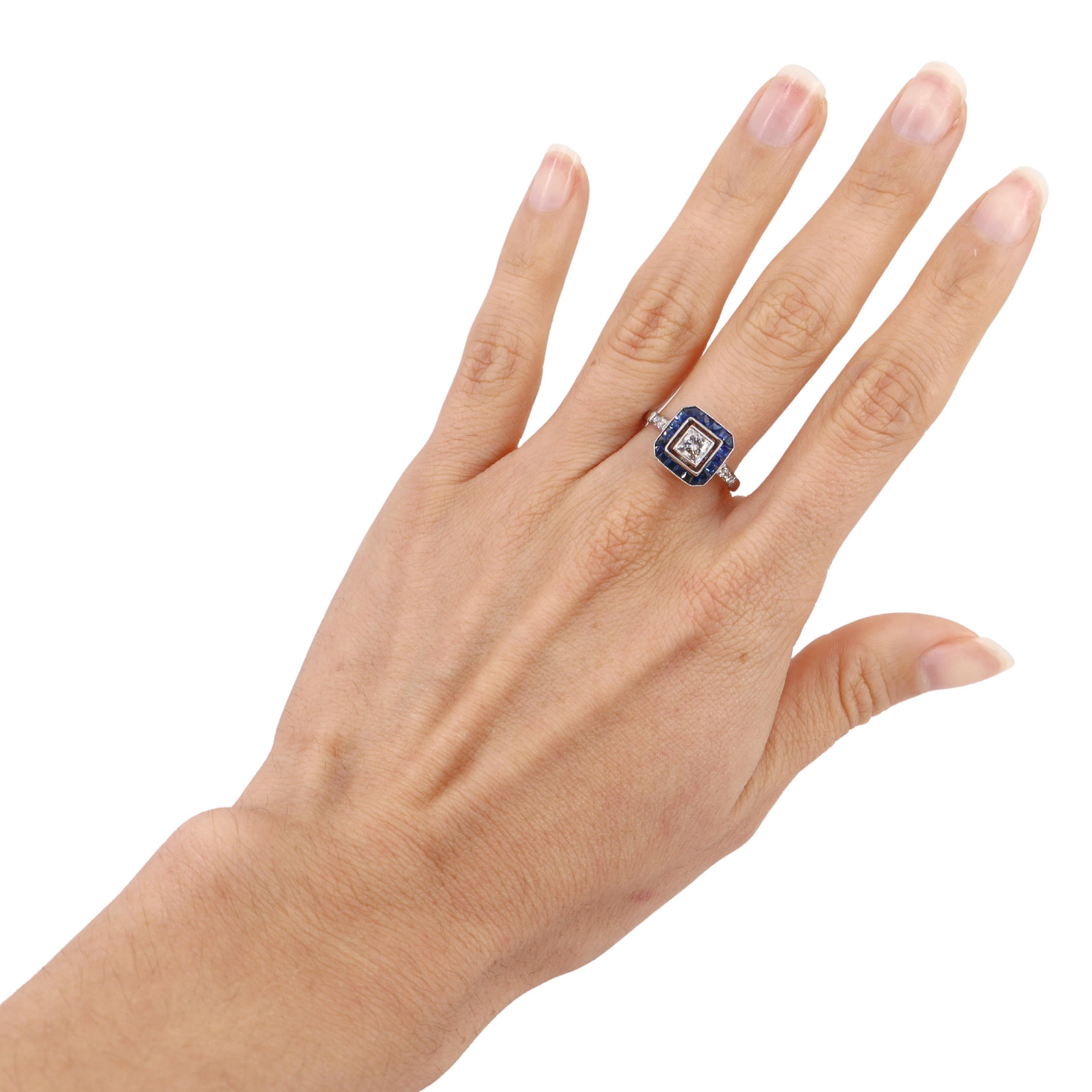 This exquisite ring showcases a harmonious blend of elegance and sophistication. Crafted in platinum, it features a striking princess-cut diamond at its center, weighing 0.45 carats. The diamond, with a clarity of VS1 and an H color grade, exudes a