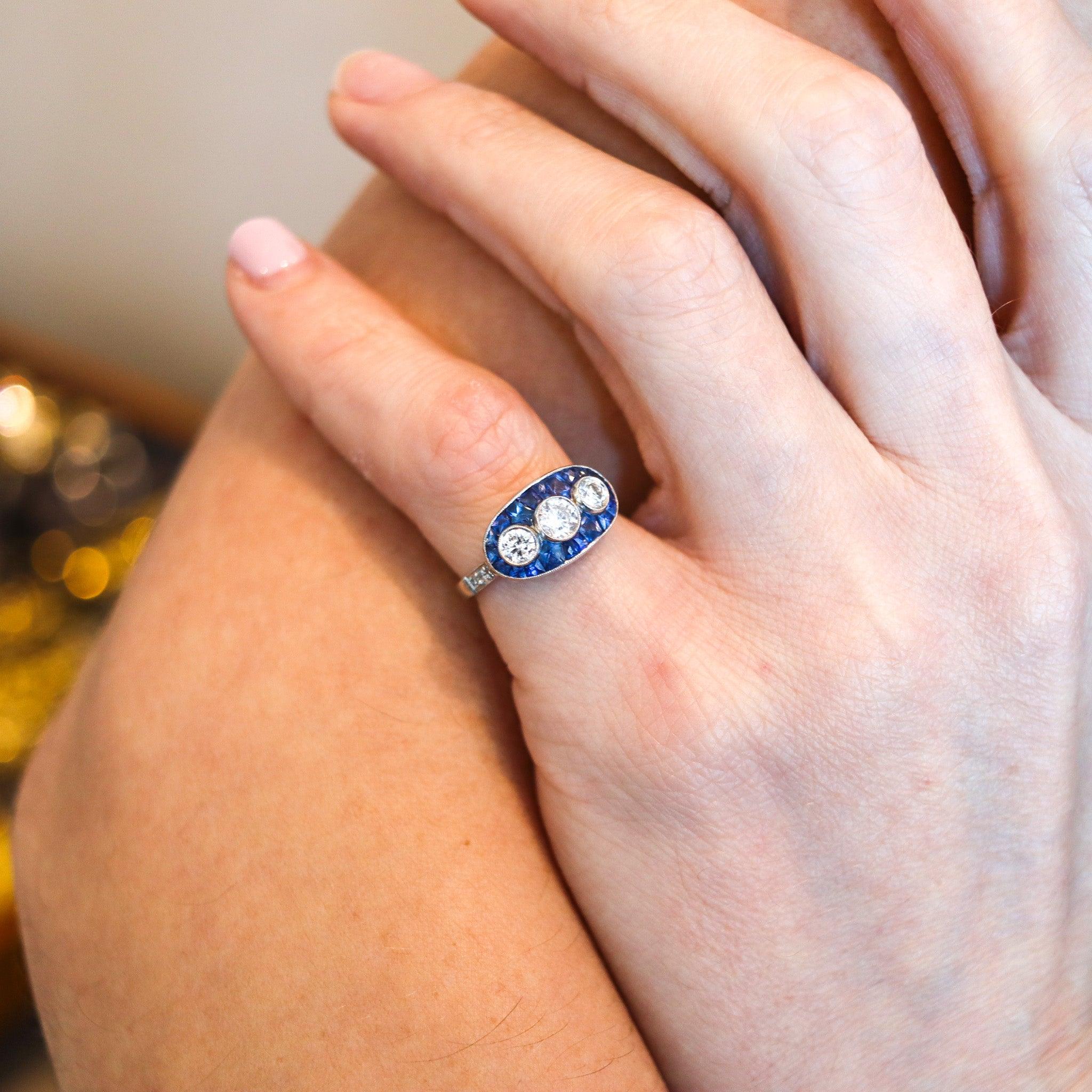 Bague art déco sertie de pierres précieuses.

Il s'agit d'une magnifique et élégante bague à trois pierres, créée pendant la période de l'art déco américain, dans les années 1930. La bague a été soigneusement fabriquée en platine massif .900/.999 et