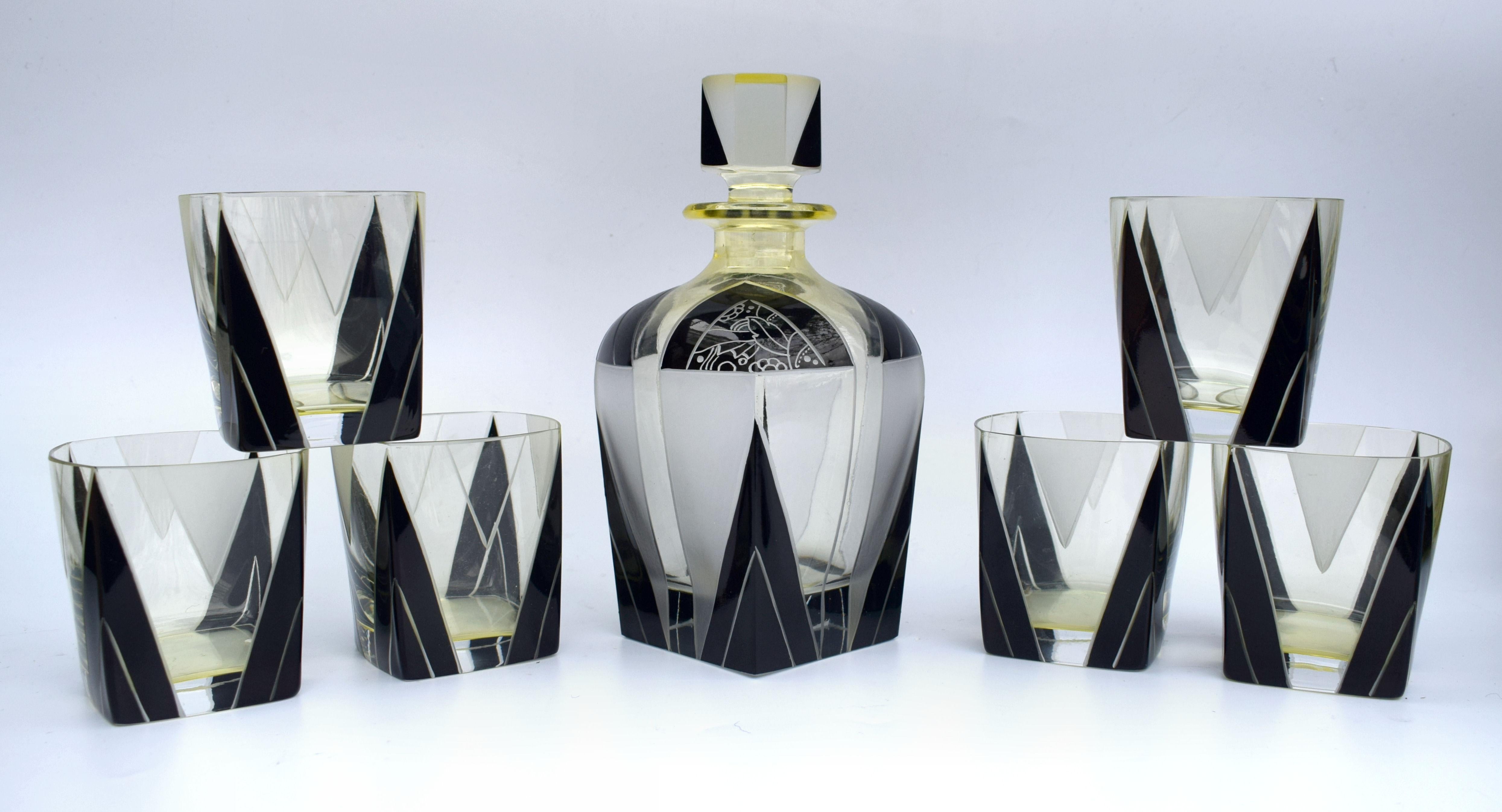 Very stylish and appealing Art Deco decanter set which comes with six matching glasses, and decanter, the whole being heavily enameled with geometric decoration. The color is a lemon yellow with black enameling and etched accents and the condition