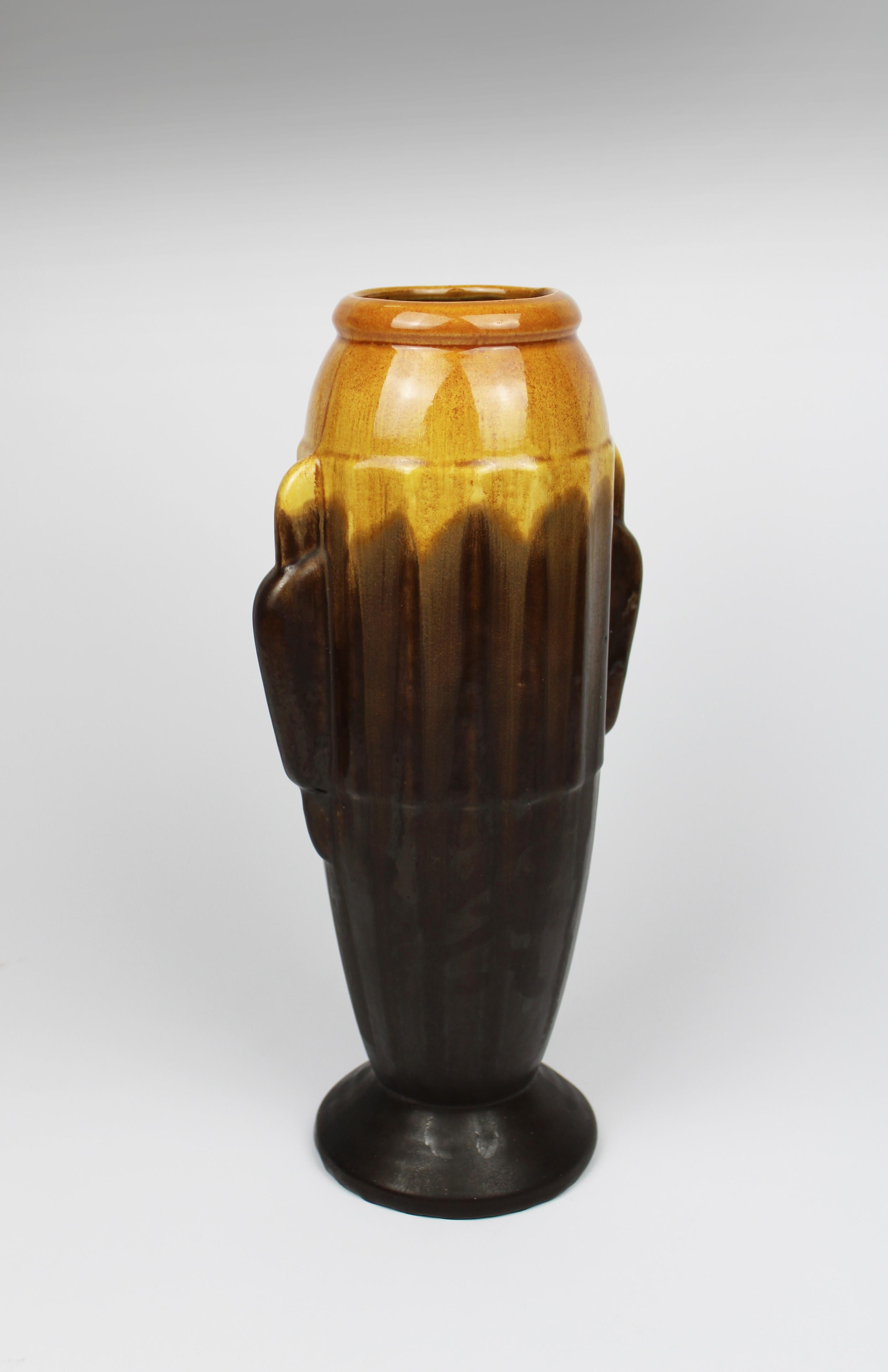Introducing an exquisite Art Deco flower vase from the 1930s, crafted in Fayence de Thulin and showcasing a stunning polychrome run glaze. This sophisticated piece, made in Belgium, is a true testament to the elegance and innovation of Art Deco