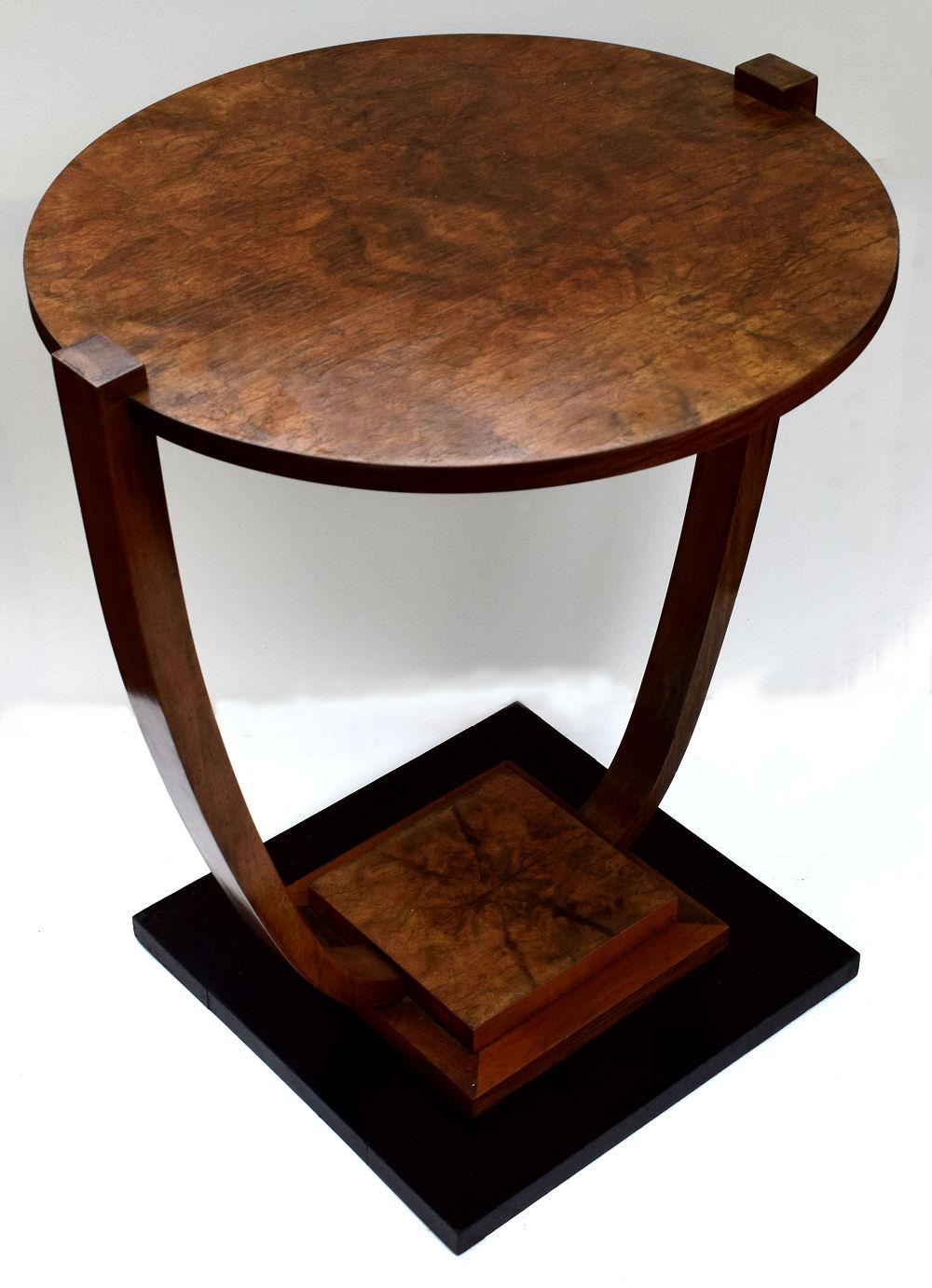 A very stylish 1930s Art Deco French occasional table very much in the style of Leleu. Beautiful walnut veneers and two-tiered with an ebonized stepped base. Typically French in style and would make a great focal point to any room, looks great from