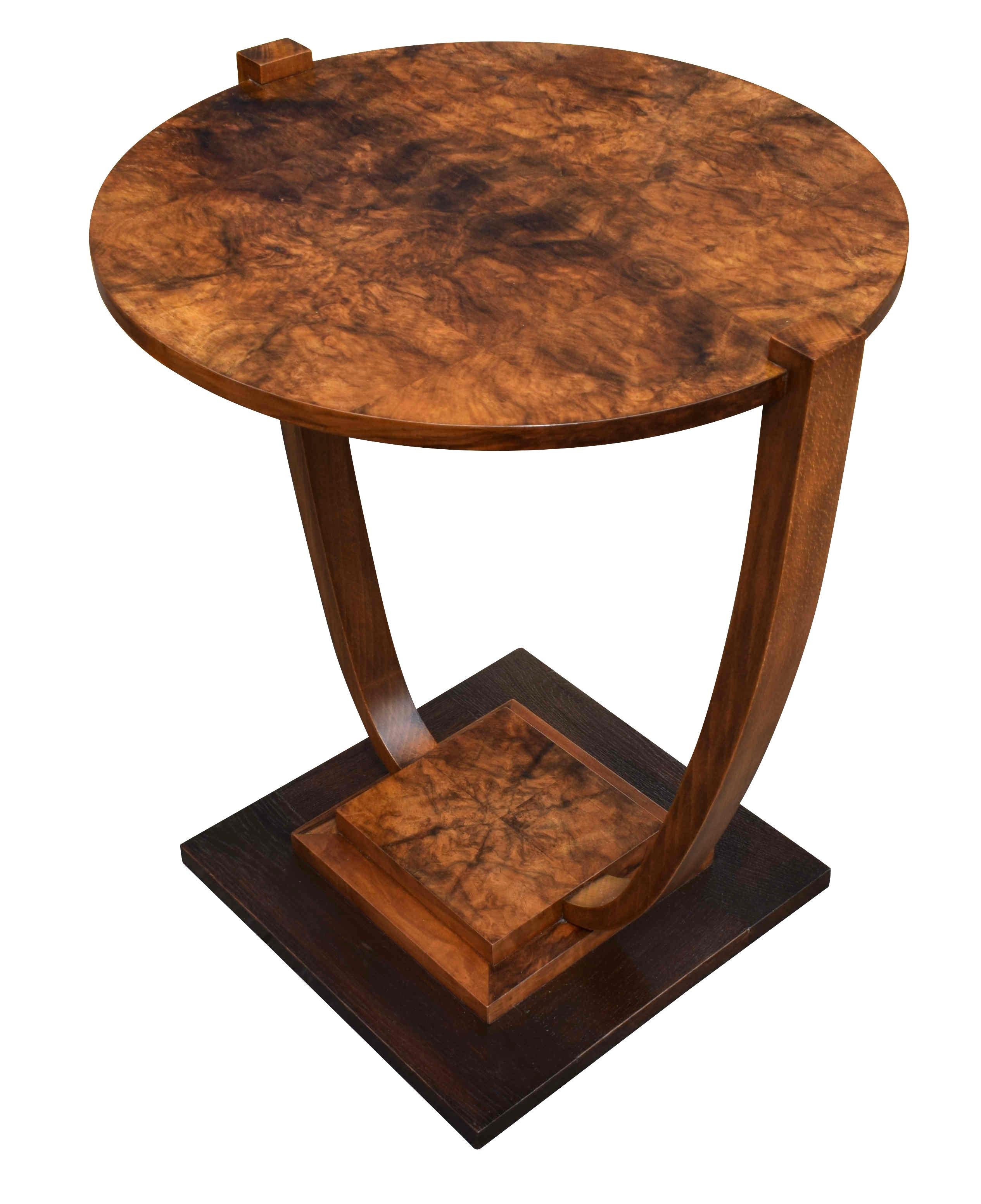 A very stylish 1930s Art Deco French occasional table very much in the style of Leleu. Beautiful walnut veneers and two-tiered with an ebonized stepped base. Typically French in style and would make a great focal point to any room, looks great from