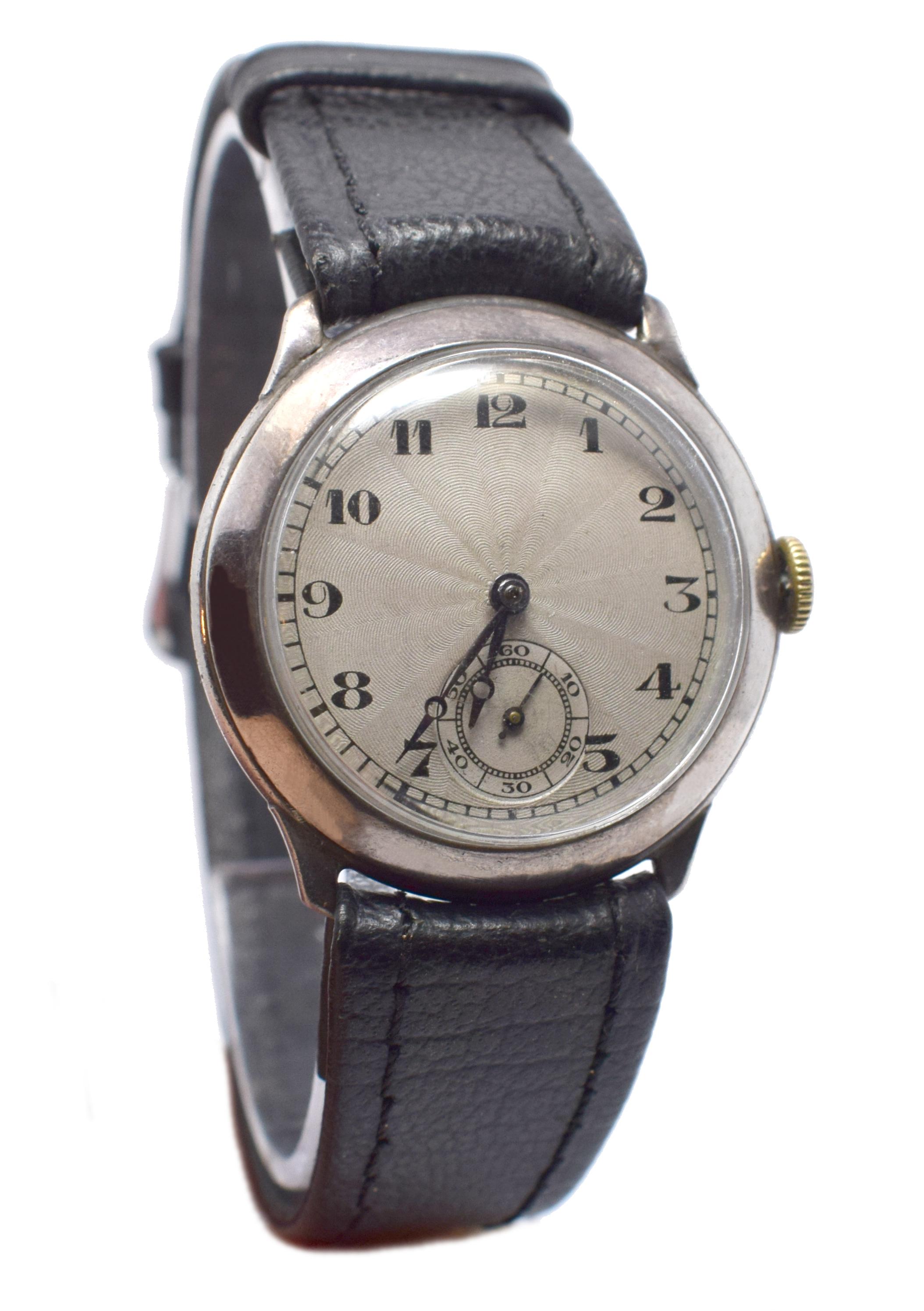 Very attractive and original 1930's gents wrist watch. The guilloche (silvered engine turned) dial has black Arabic numerals with a subsidiary seconds dial.  Serviced and keeping good time, a new leather strap has been added. Ideal for day and