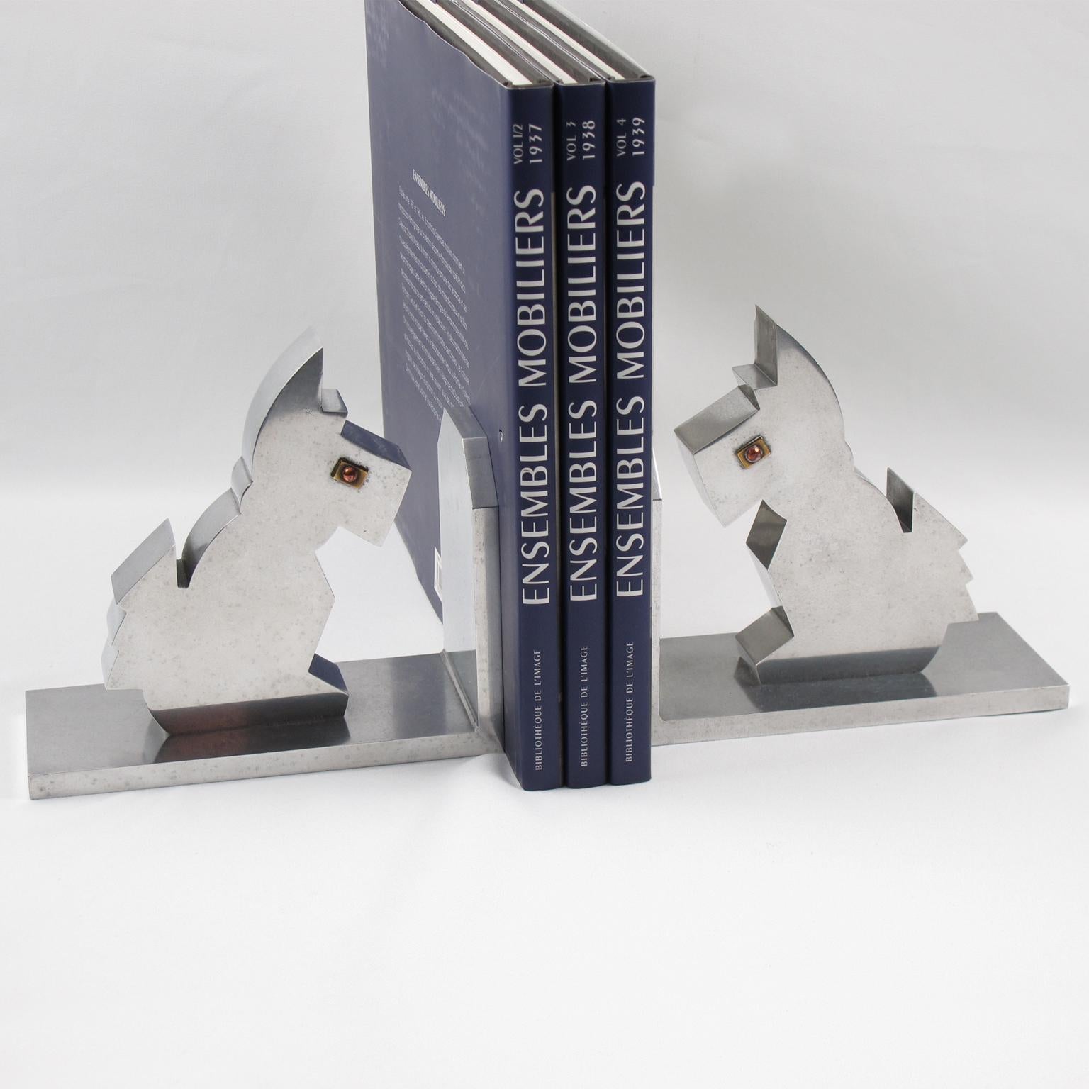 Lovely pair of French Art Deco cast aluminum bookends. Featuring cute metal Scottie dogs with brass and copper eyes. Great geometric modernist cubist shape. Heavy and definitively usable as real bookends. No visible maker's mark.
Measurements: 6.32