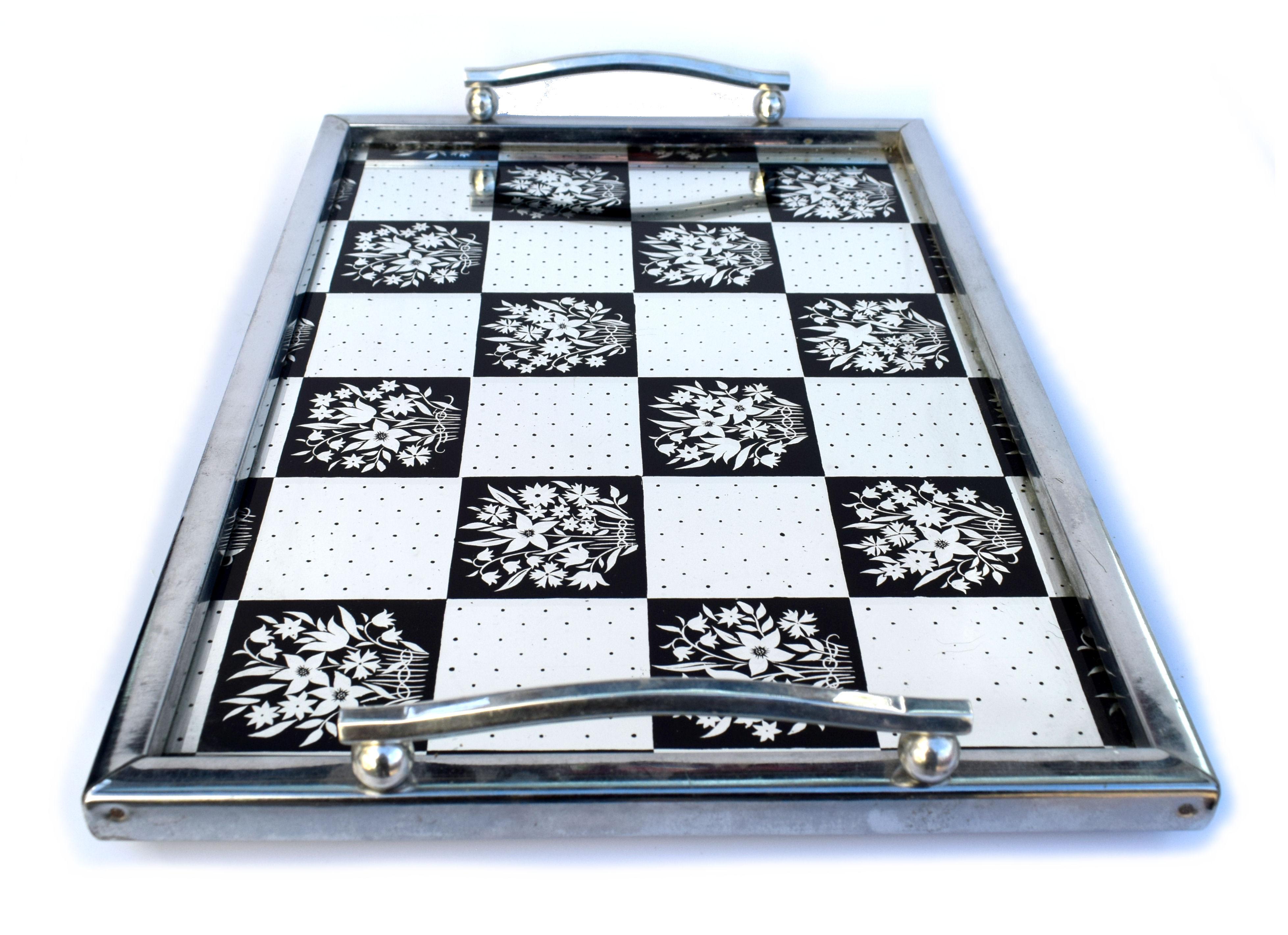 Very stylish and in superb condition is this English, 1930s Art Deco mirrored drinks tray. The chrome surround and handles with ply base support a chequered effect mirrored glass base. Very glamorous and ideal for serving drinks on or even use as