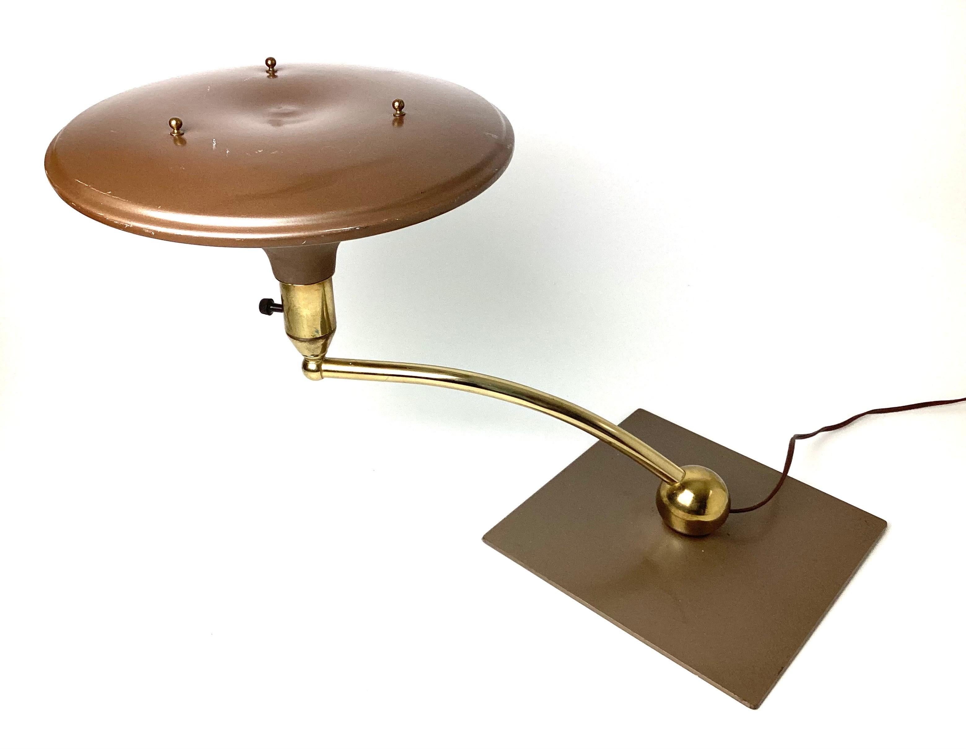 Art Deco 1930s Modern sight light table lamp. Brass with copper baked brown enamel shade and base. Arm swivels. Age appropriate condition with some minor ware to the paint.
