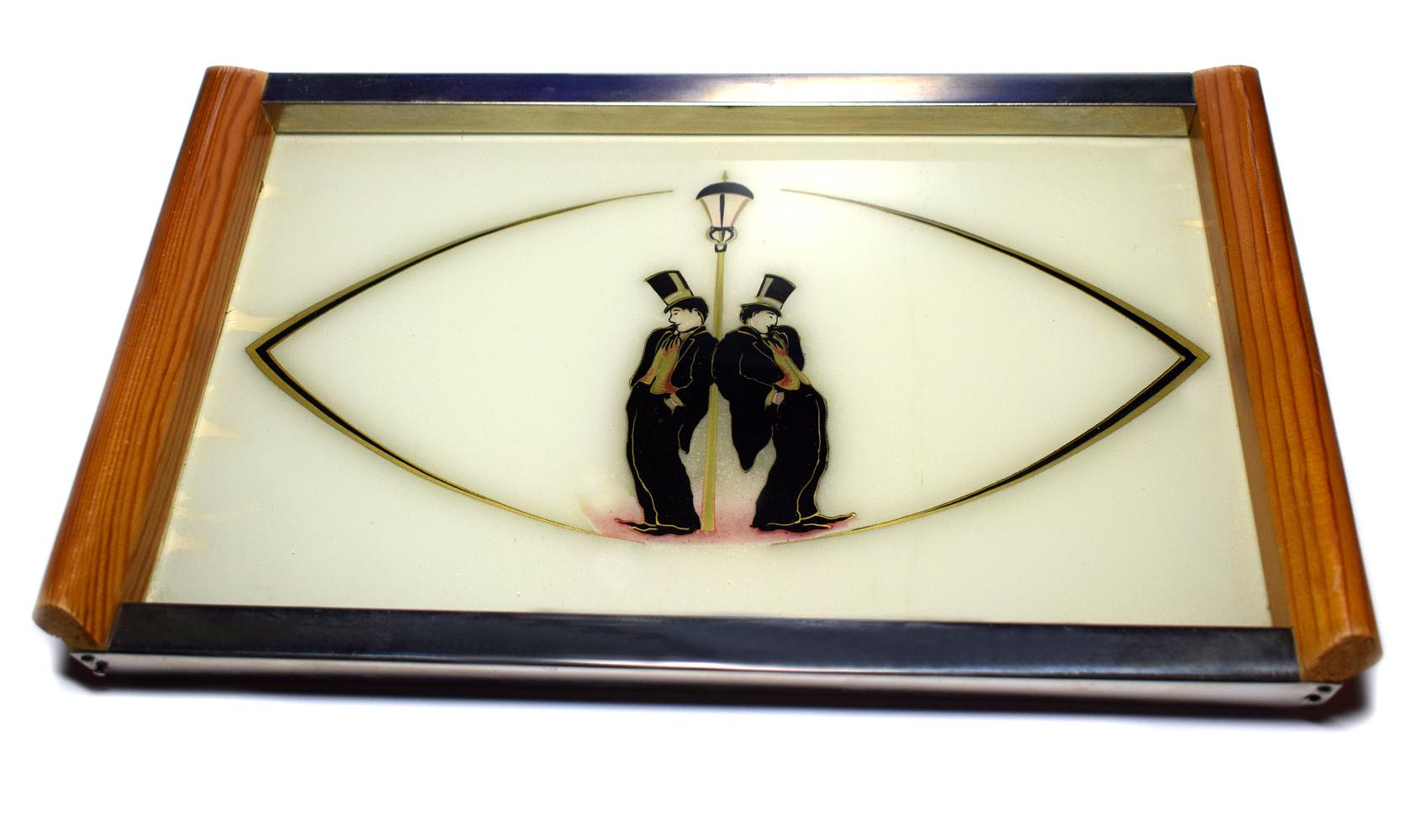 A rare and very collectable 1930s Art Deco cocktail drinks tray depicting two stylized Charlie Chaplin's leaning against a lamp post. Very charming and also classy. Ideal size for modern day use or just to enhance a bar setting. Condition is very