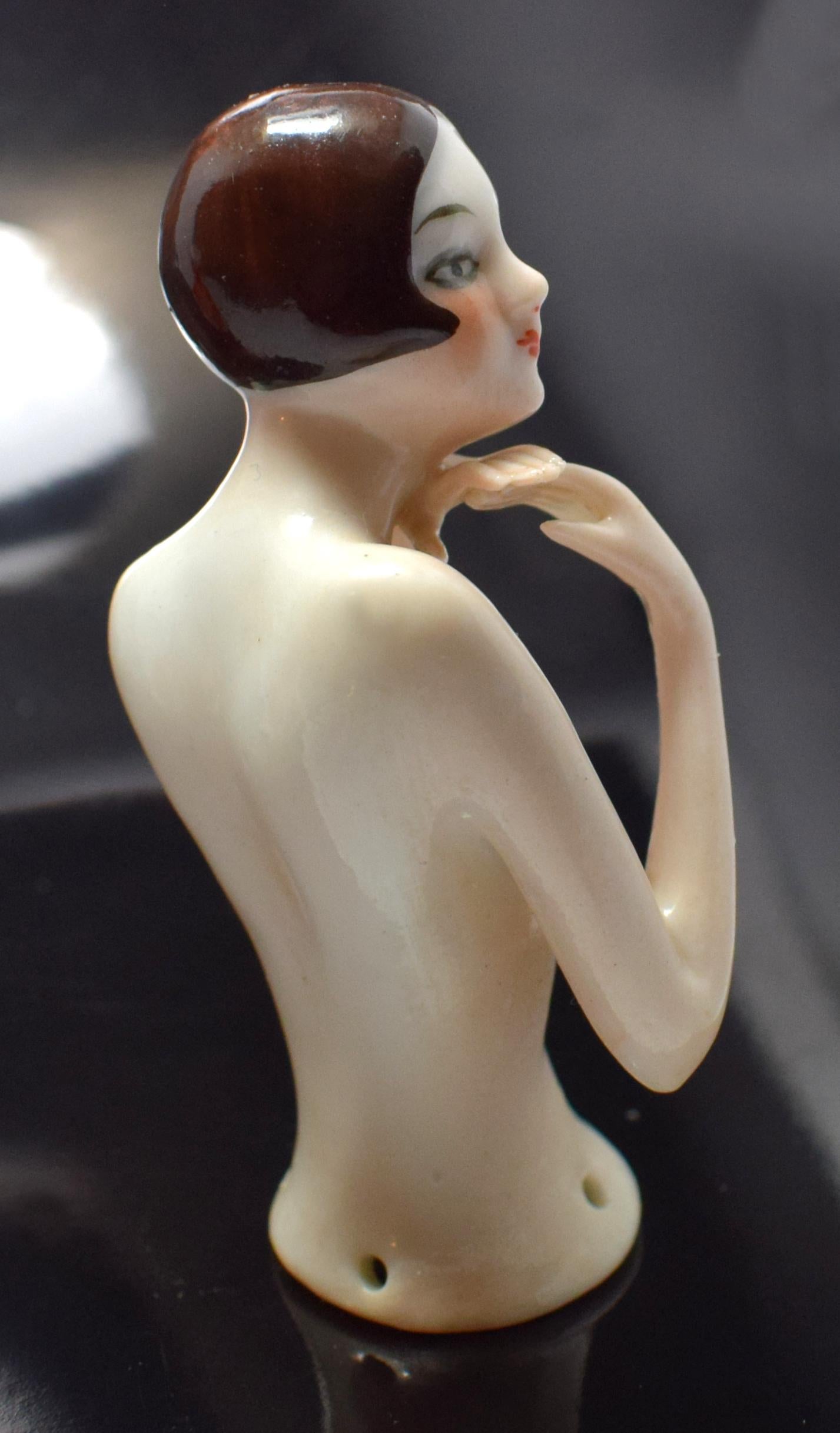 Beautiful Art Deco 1920s pin cushion half doll manufactured by the factory of Carl Schneider. This pin doll is in the form of a nude flapper lady with centre parted glossy dark brown geometric bobbed hair. The doll has long, lean torso with slim