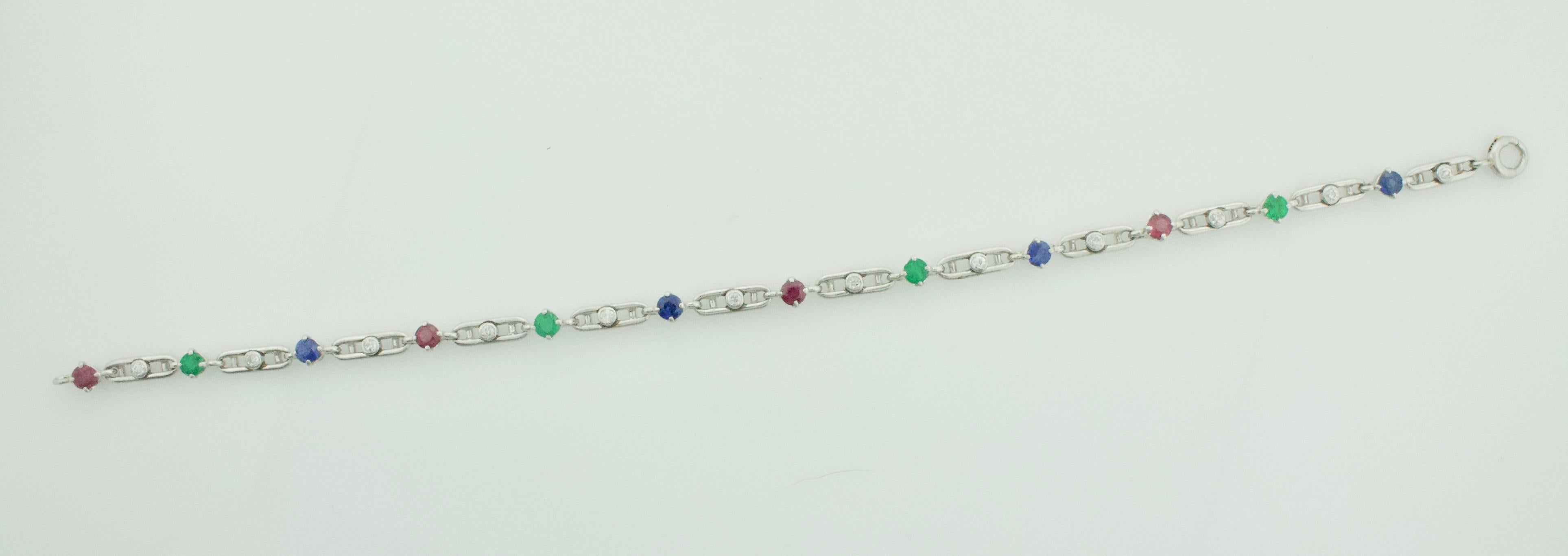 Art Deco 1930's Ruby, Emerald, Sapphire and Diamond Bracelet in Platinum
12 European Cut Diamonds Weighing .35 Carats Approximately [GHI/VVS-SI1]
4 Round Rubies Weighing .50 Carats Approximately 
4 Round Emeralds Weighing .40 Carats Approximately 
4