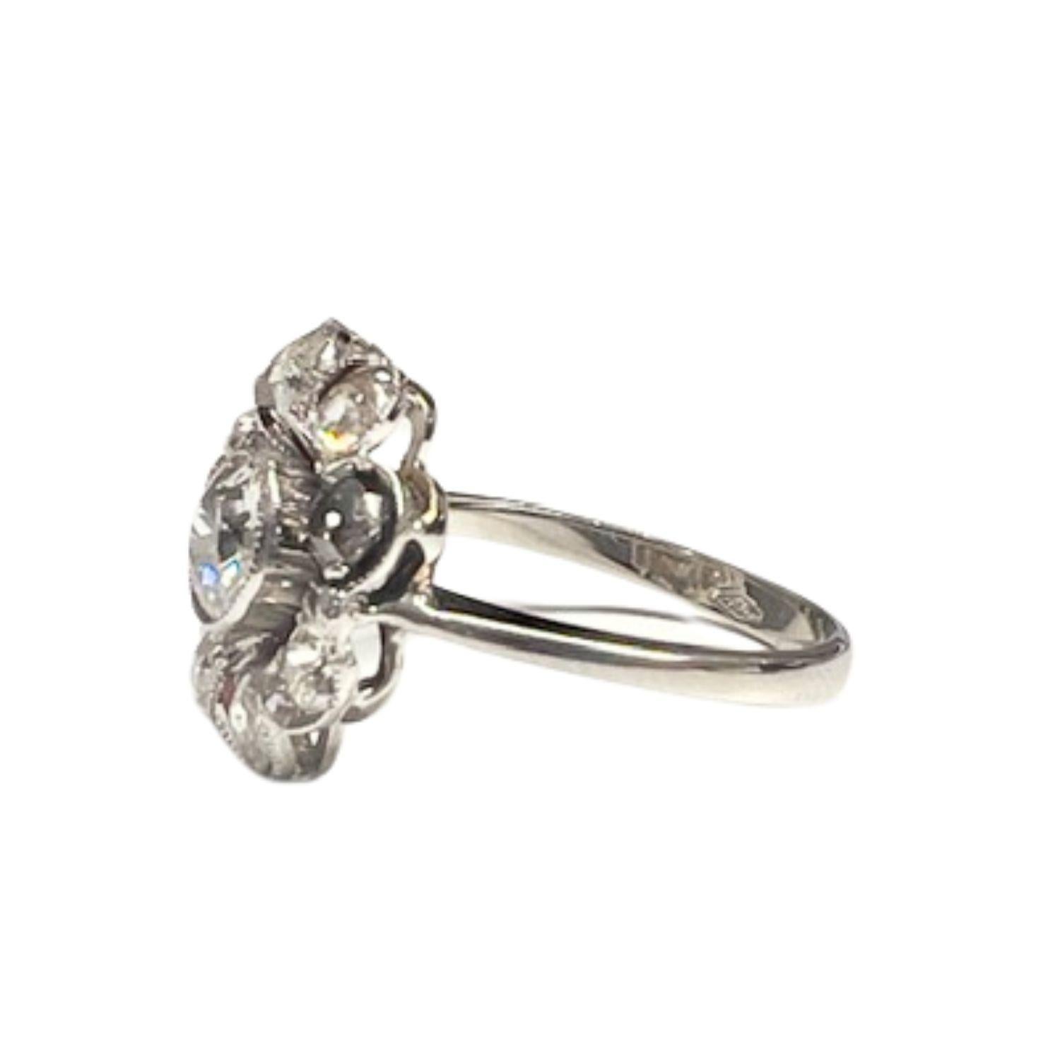 This ring features an Art Deco design from 1935, crafted in 18K gold and adorned with Diamonds arranged in a floral motif. 
The center of the flower features a 0.60 carat Diamond. 
The Diamonds are antique-cut, with a total weight of 1.40 carats and