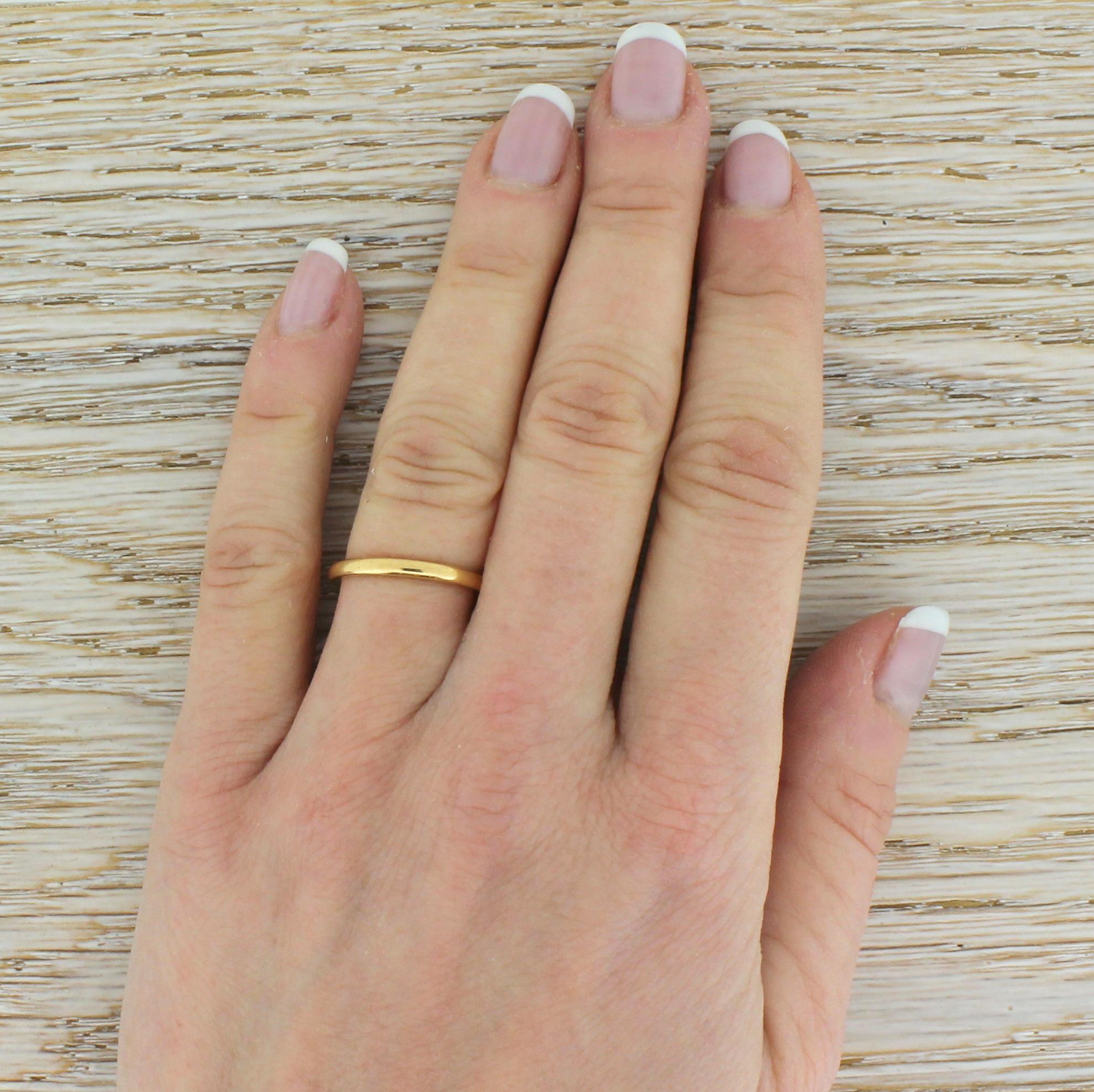 An exceptional and wearable antique wedding band ring. This slim, court shaped band is crafted in a warm hued 22k yellow gold. With clear internal hallmarks indicating the Birmingham Assay, 1939.

Size – L (UK) or 5 7/8 (US). Complimentary sizing is