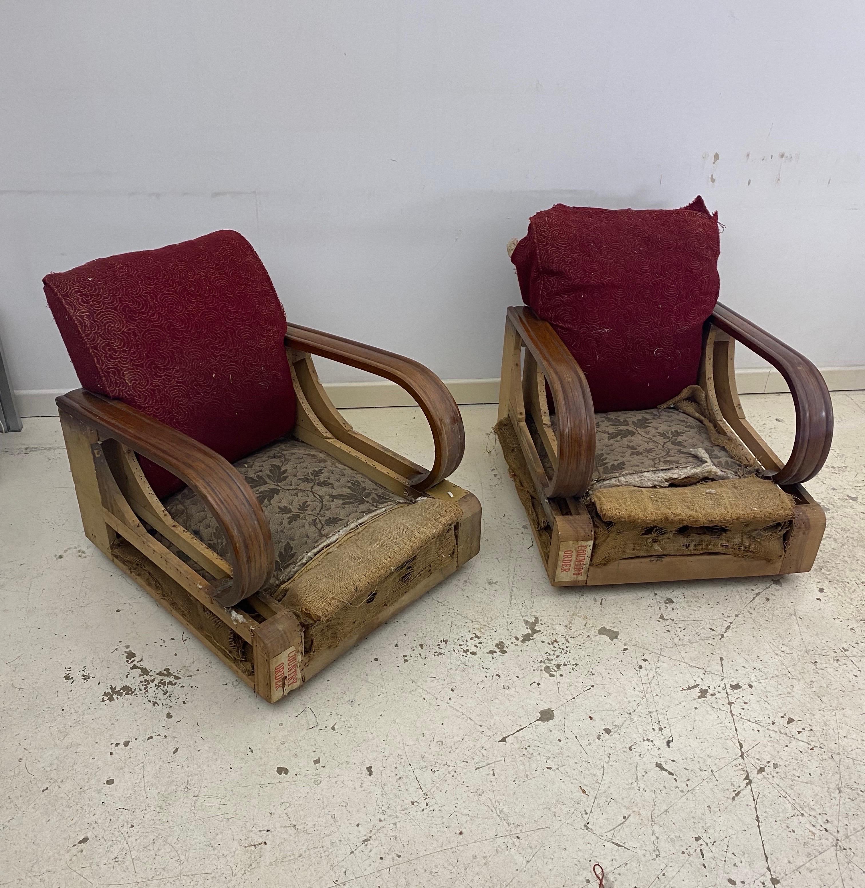 1940s Art Deco pair of distressed armchairs, featuring timeless oak wood arms, as seen at Hercule Poirot BBC series. 

This piece requires comprehensive restoration due to woodworm damage affecting the frame, the arms are not affected. Once the